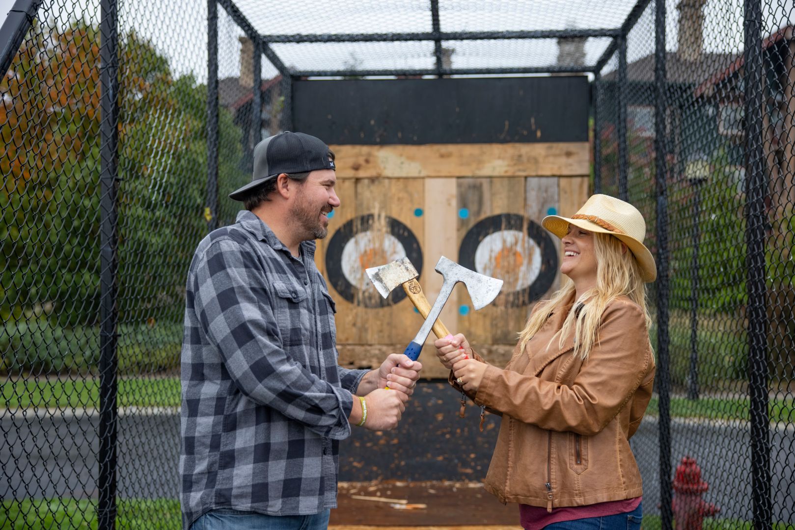 Couple doing axe throwing.