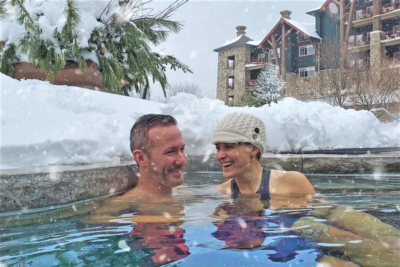 Couple enjoying the snow pool at Grand Cascades Lodge