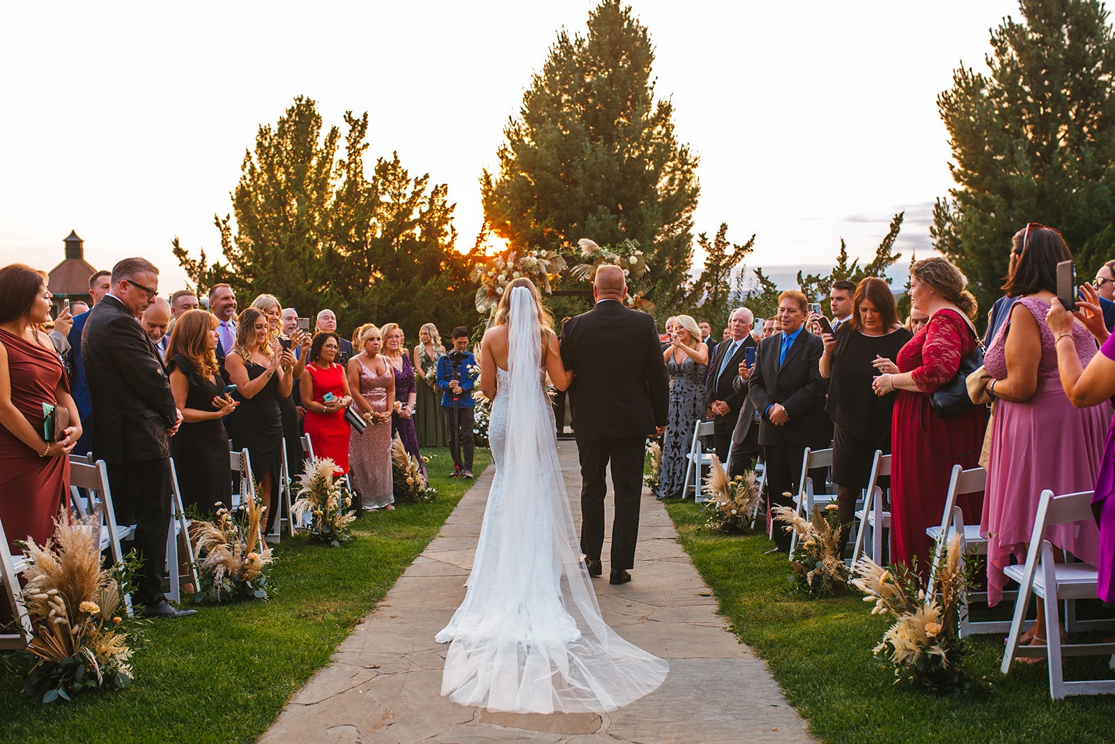 Bride walking down the aisle at Wedding Garden ceremony space at Crystal Springs Country Club. 