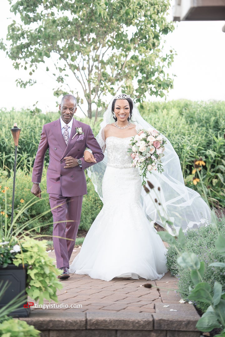 Bride walks down aisle with father during ceremony at Ballyowen Wedding Garden.