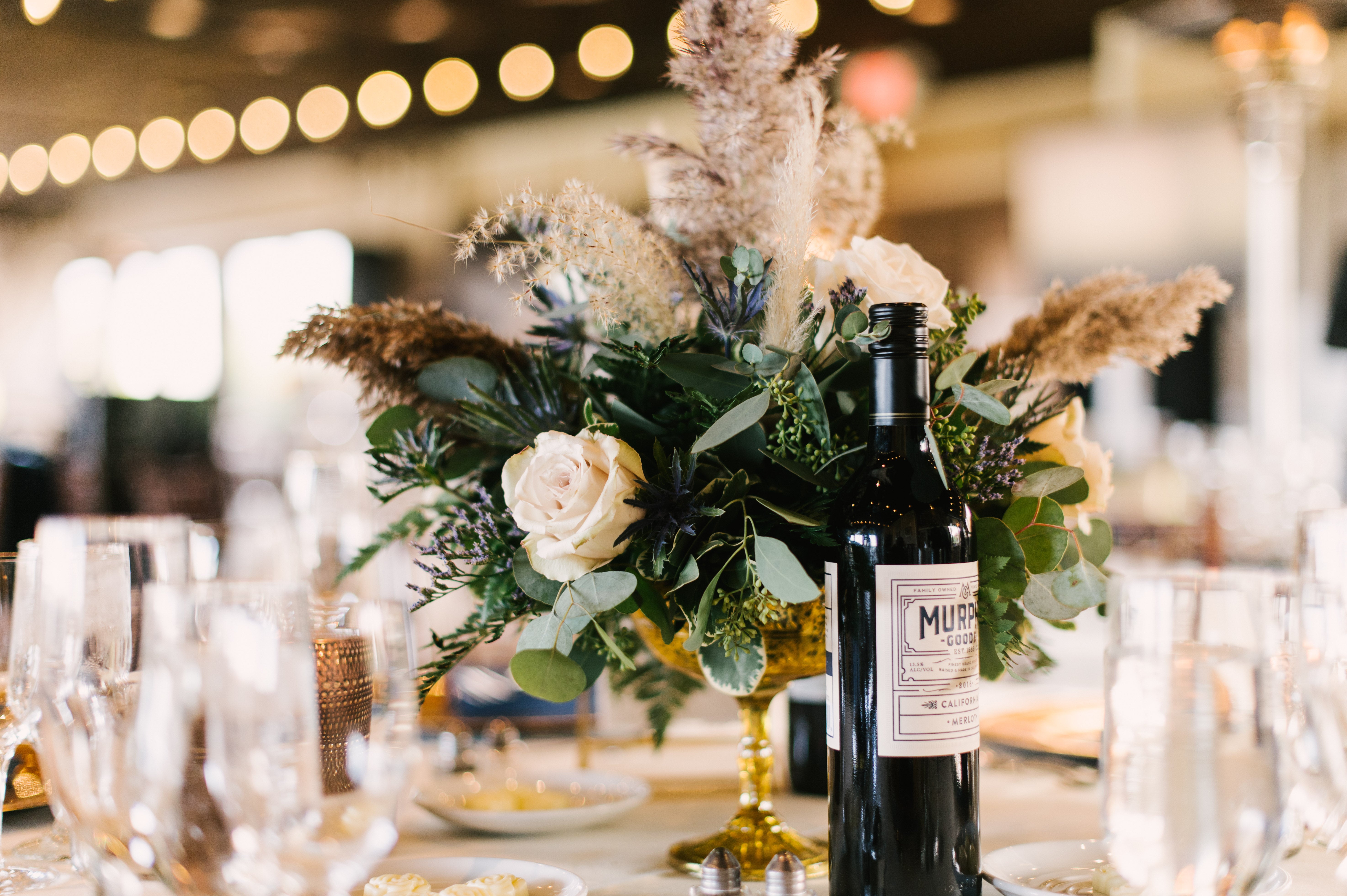 Flowers on table with wine during a Ballyowen Bailigh Bluff House wedding reception.