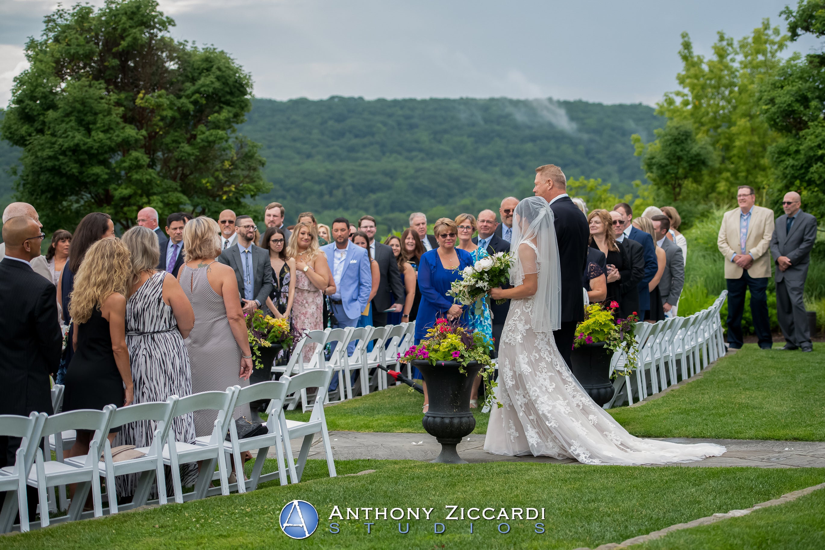 Bride walking down the aisle at Wedding Garden ceremony space at Crystal Springs Country Club. 