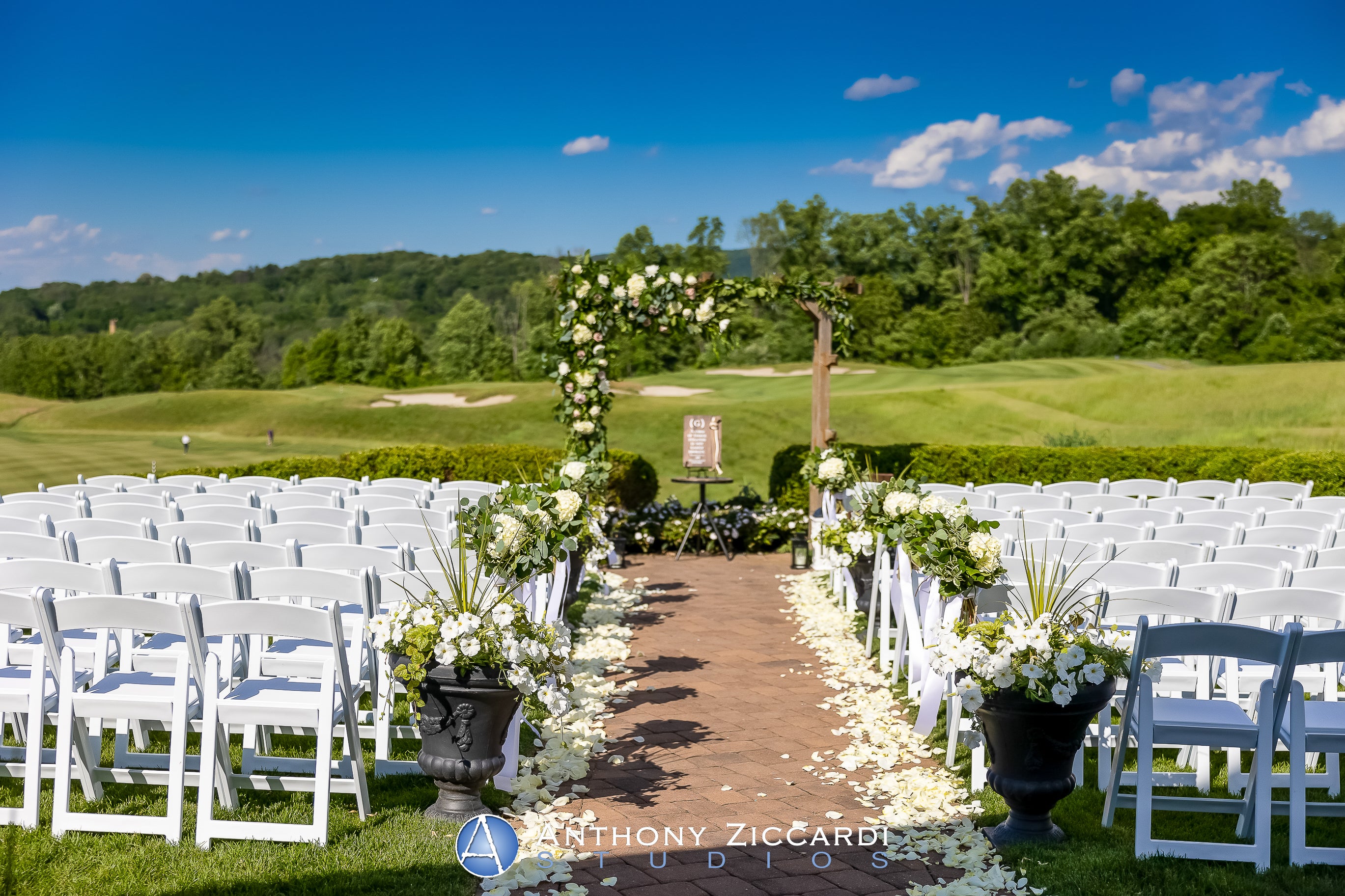 Ballyowen Wedding Garden ceremony featuring white chairs and floral arch.