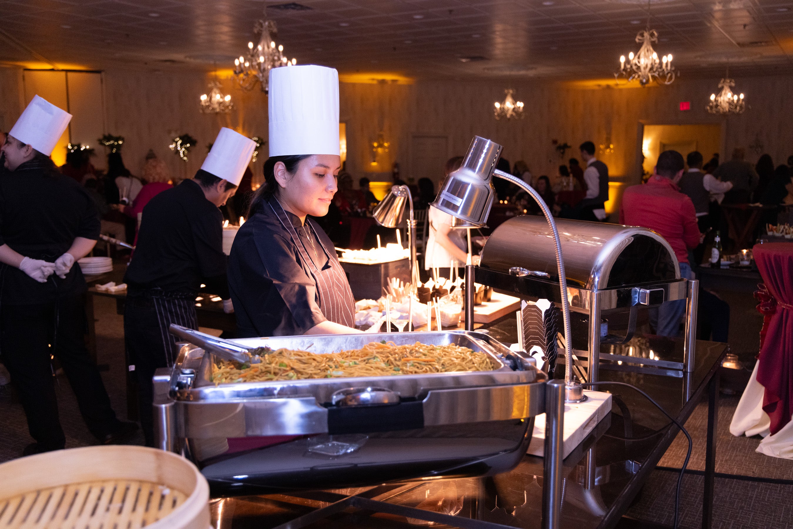 Chef distributing food in Diamond Cocktail Room. 