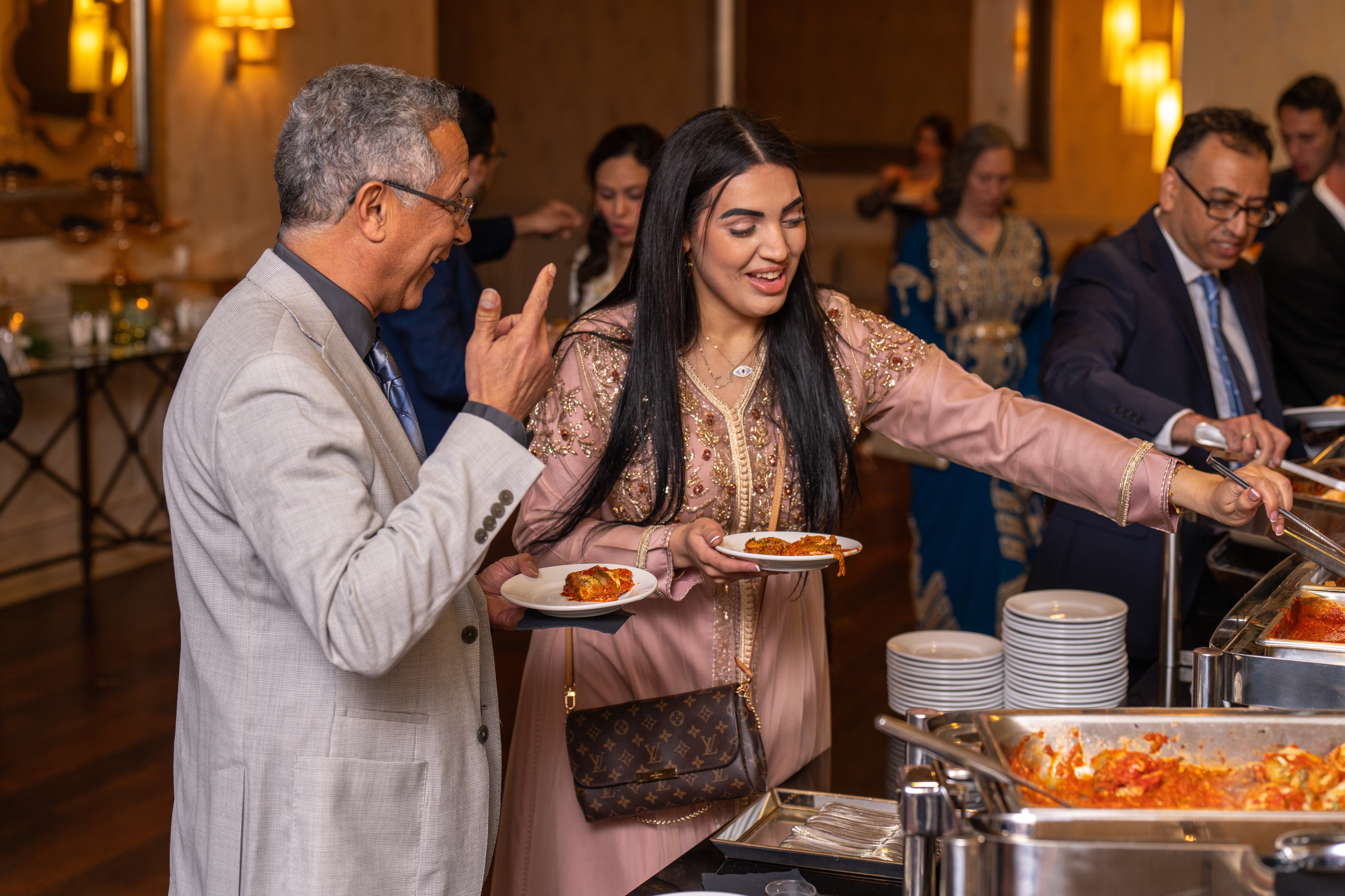 Guests getting food during cocktail hour at wedding. 