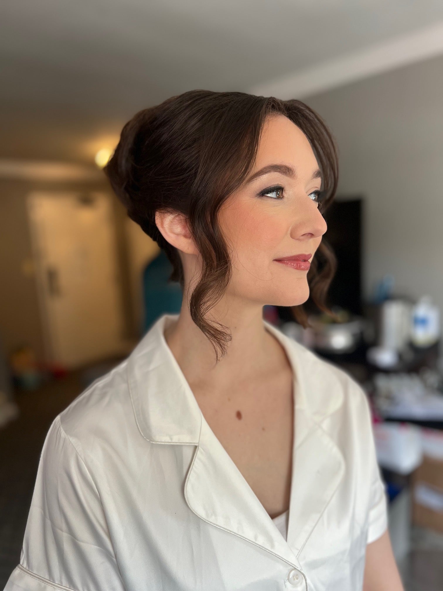 Side profile of woman with updo hairstyle. 