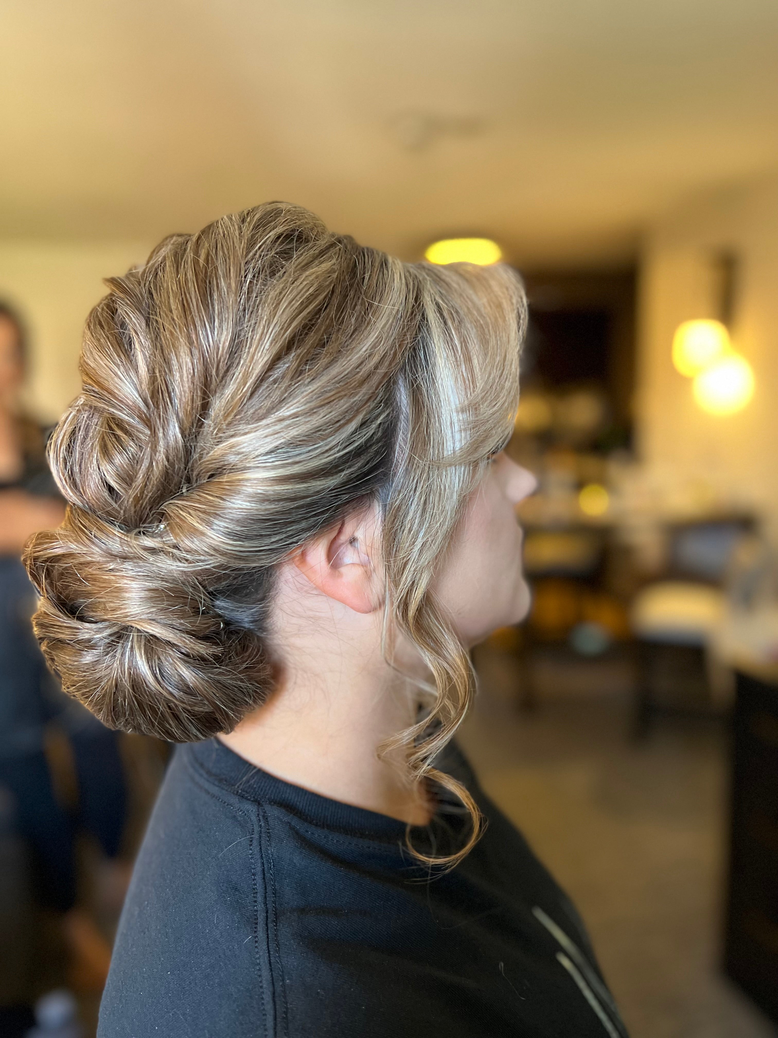 Side profile of woman with updo hairstyle. 