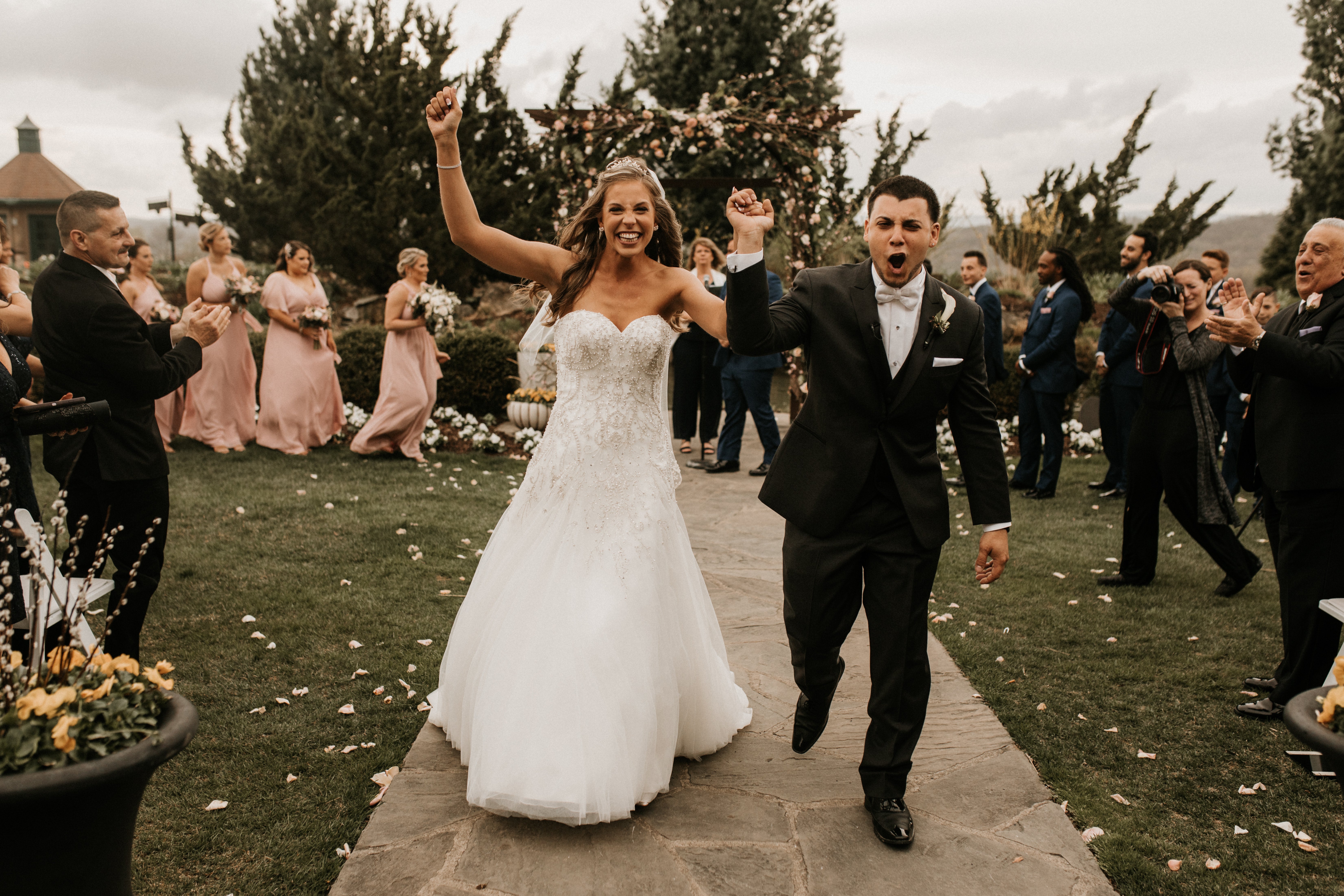 Bride and groom walk down aisle at Bride walking down the aisle at Wedding Garden ceremony space at Crystal Springs Country Club. 
