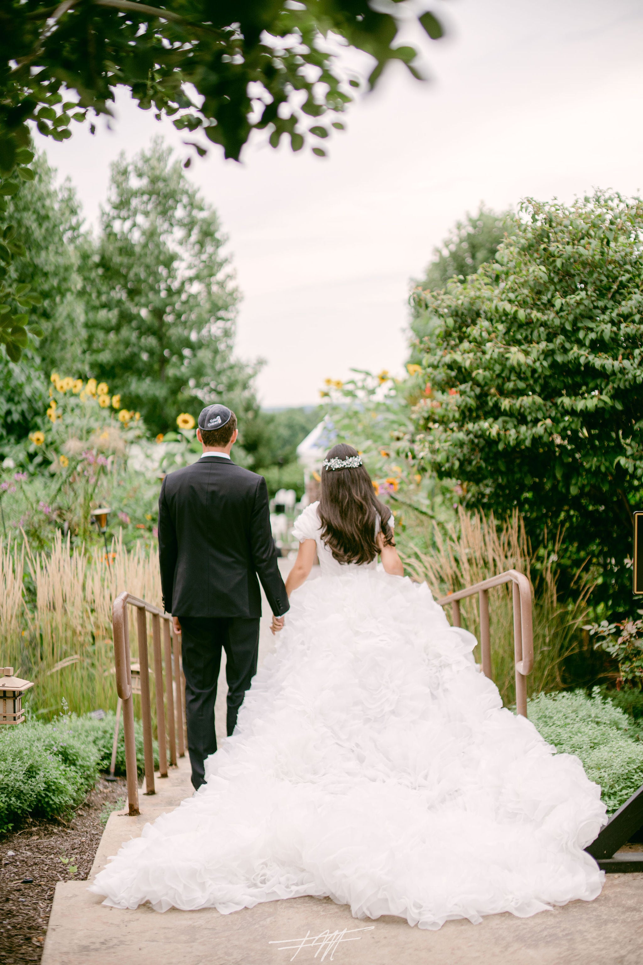 Bride and Groom holding hands. 