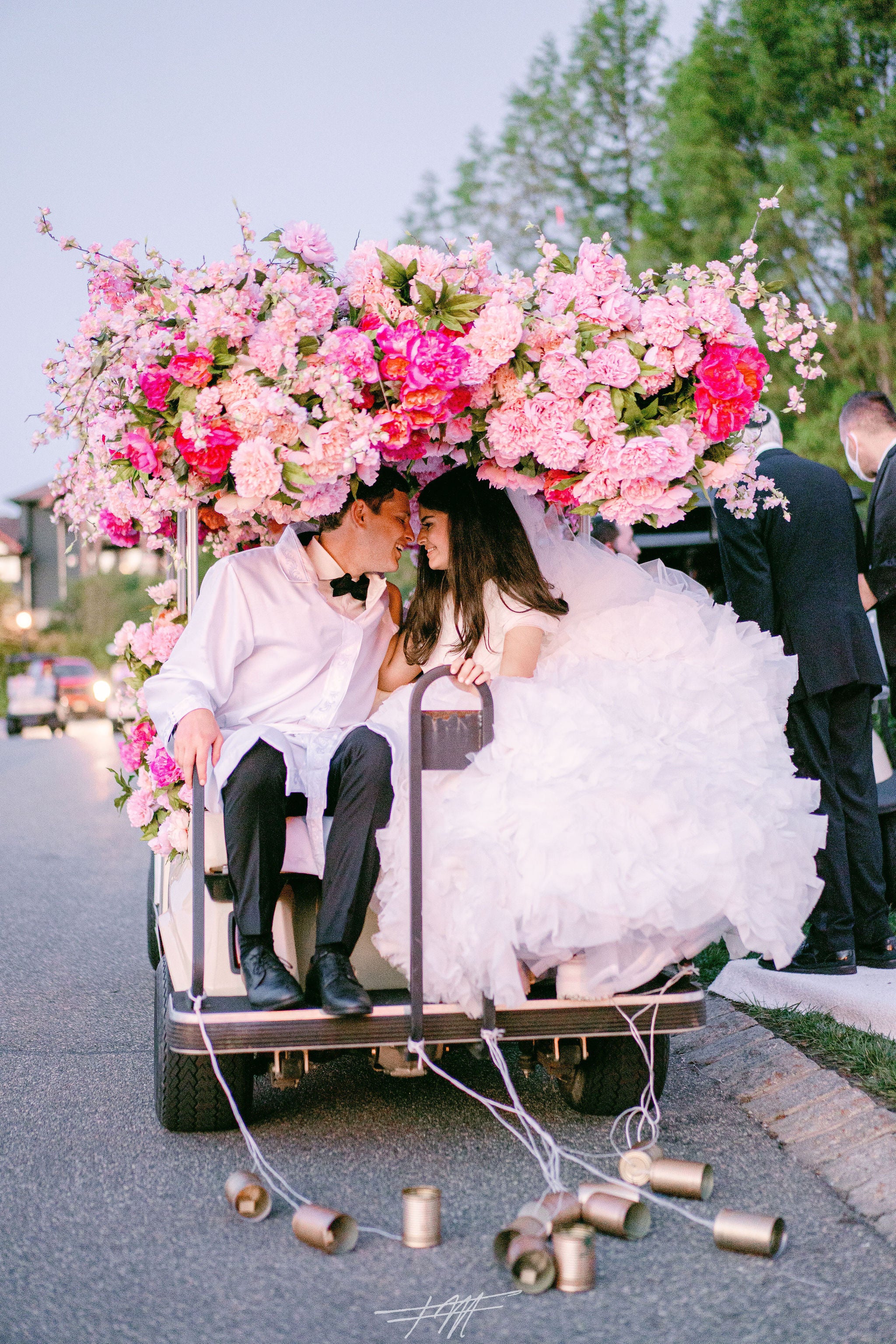Bride and groom on golf cart during their exit from wedding reception at Big Sky Pavillion.