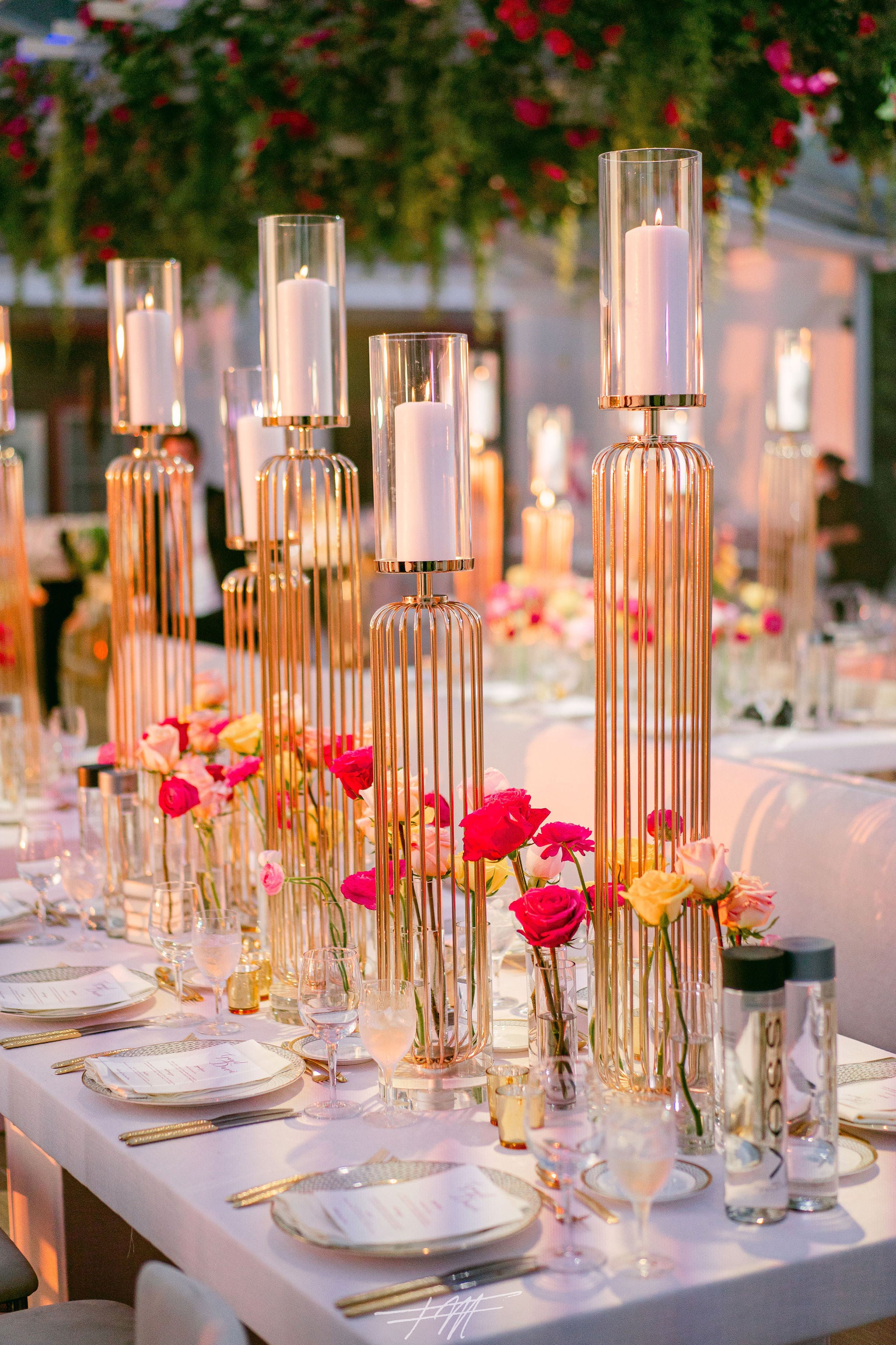 Table decor featuring pink flowers at wedding reception in Big Sky Pavillion.