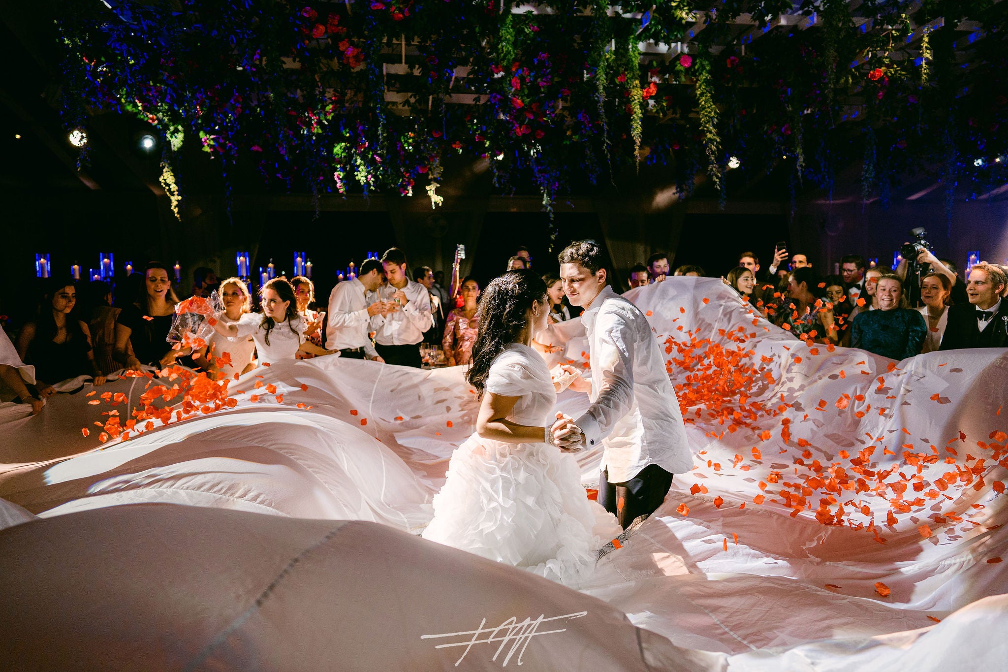 Bride and groom dancing surrounded by flowers at their wedding reception in Big Sky Pavillion.