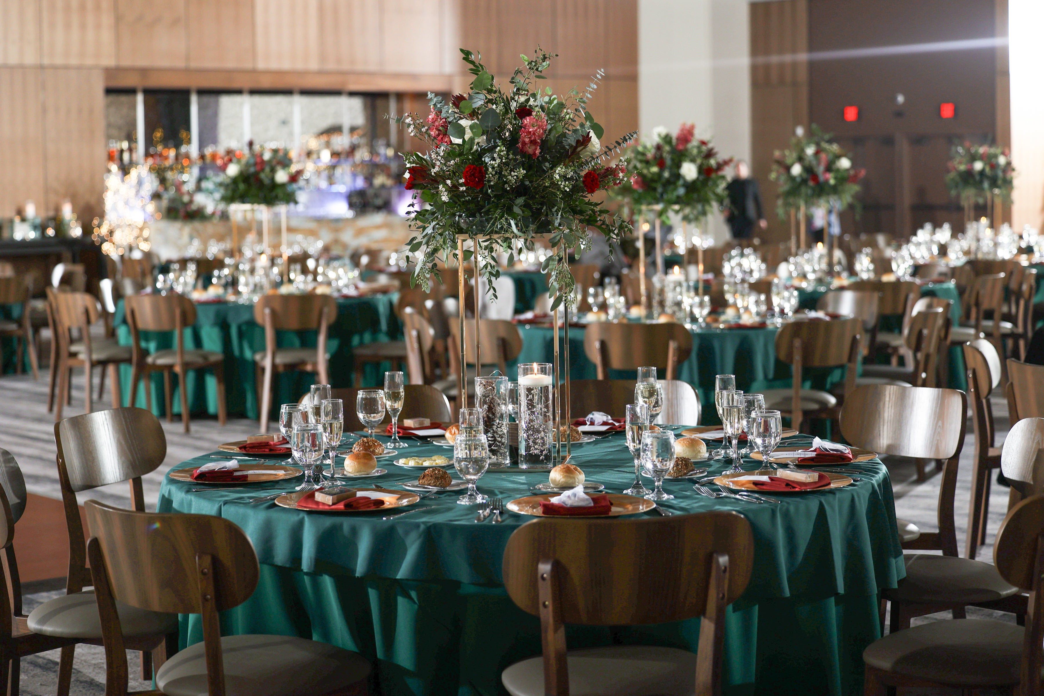Round tables set up with green tablecloths for wedding reception in the Canyon Ballroom.