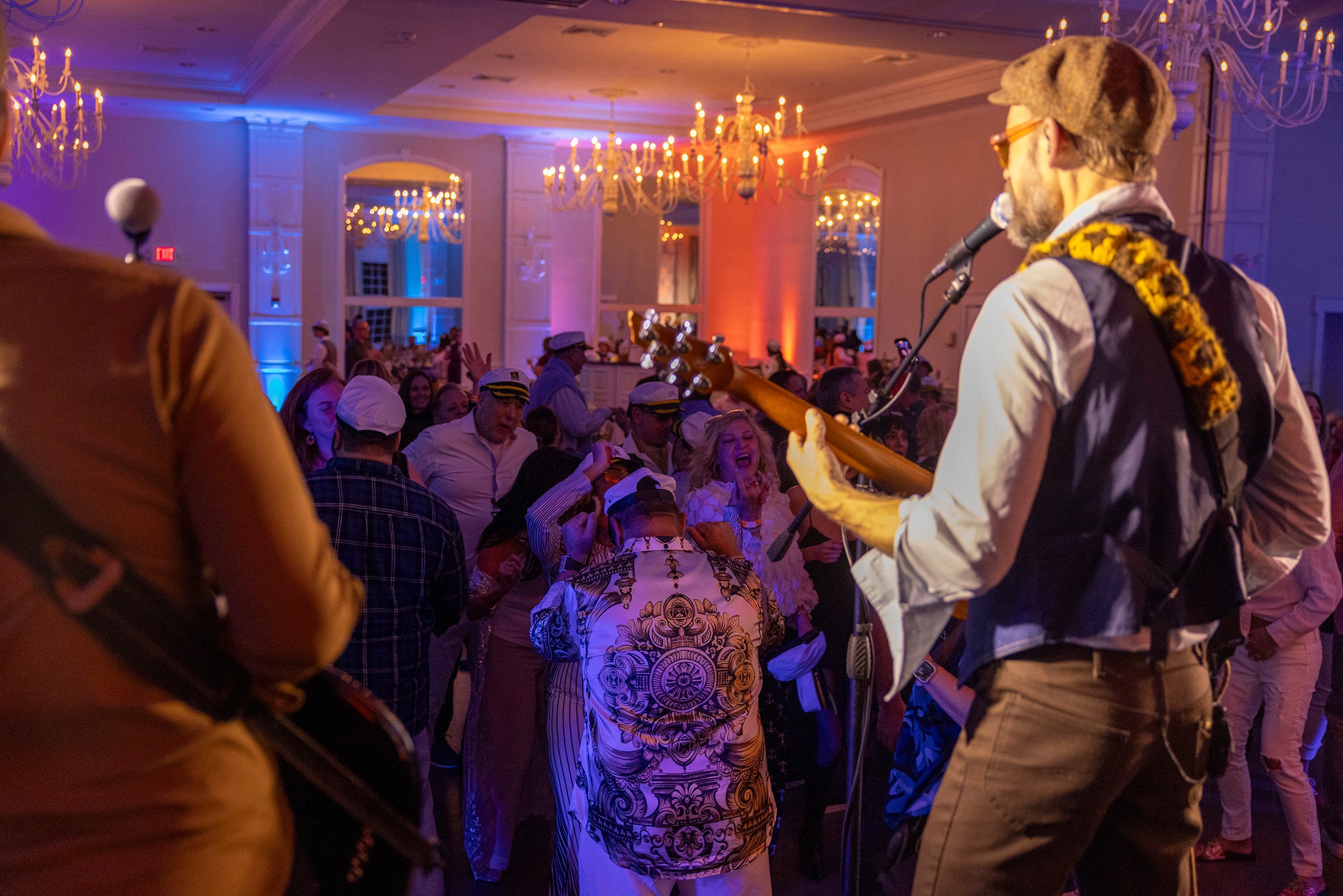 Man performing on stage in front of dancing crowd at Yacht Rock.