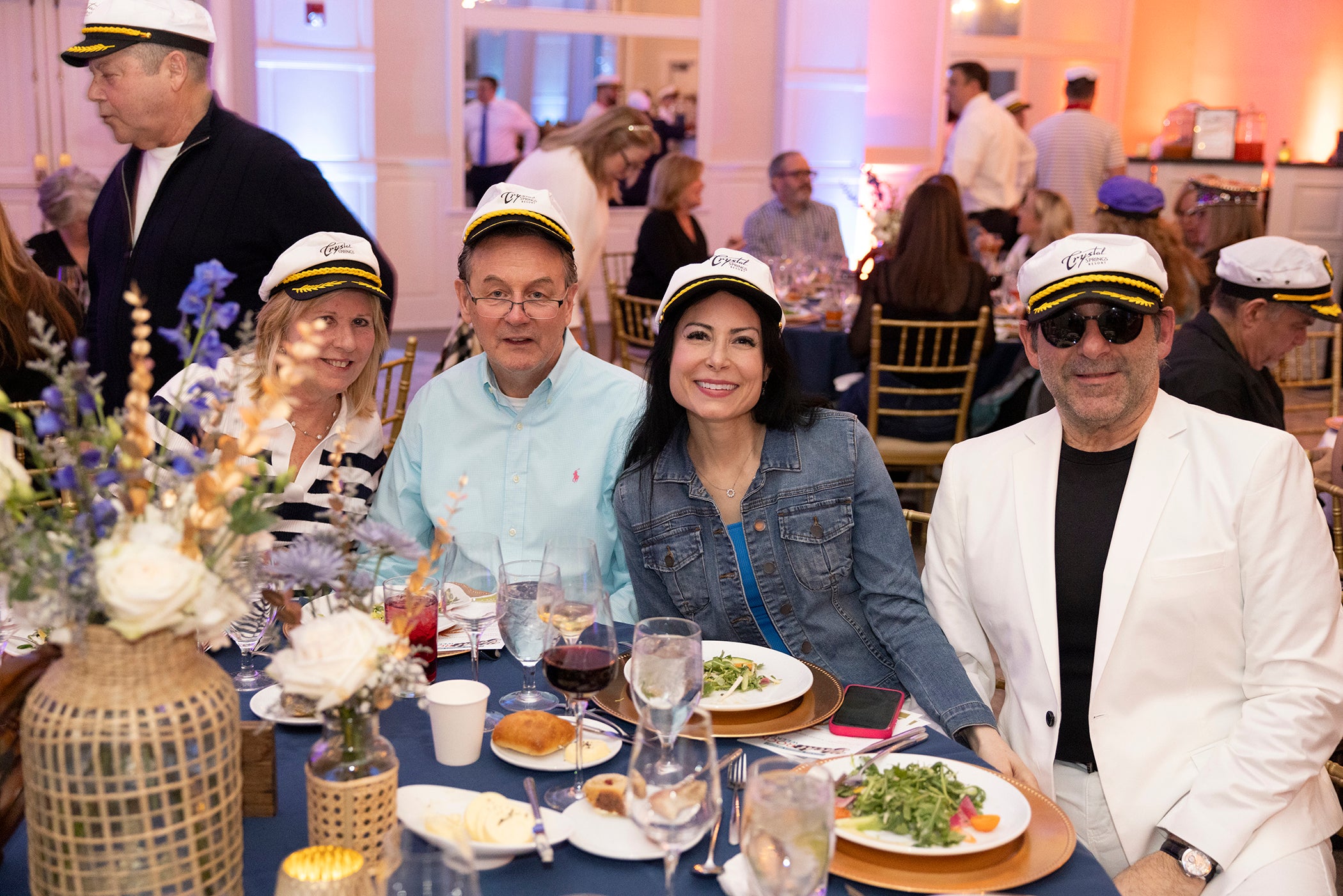Group of friends sit together at Yacht Rock