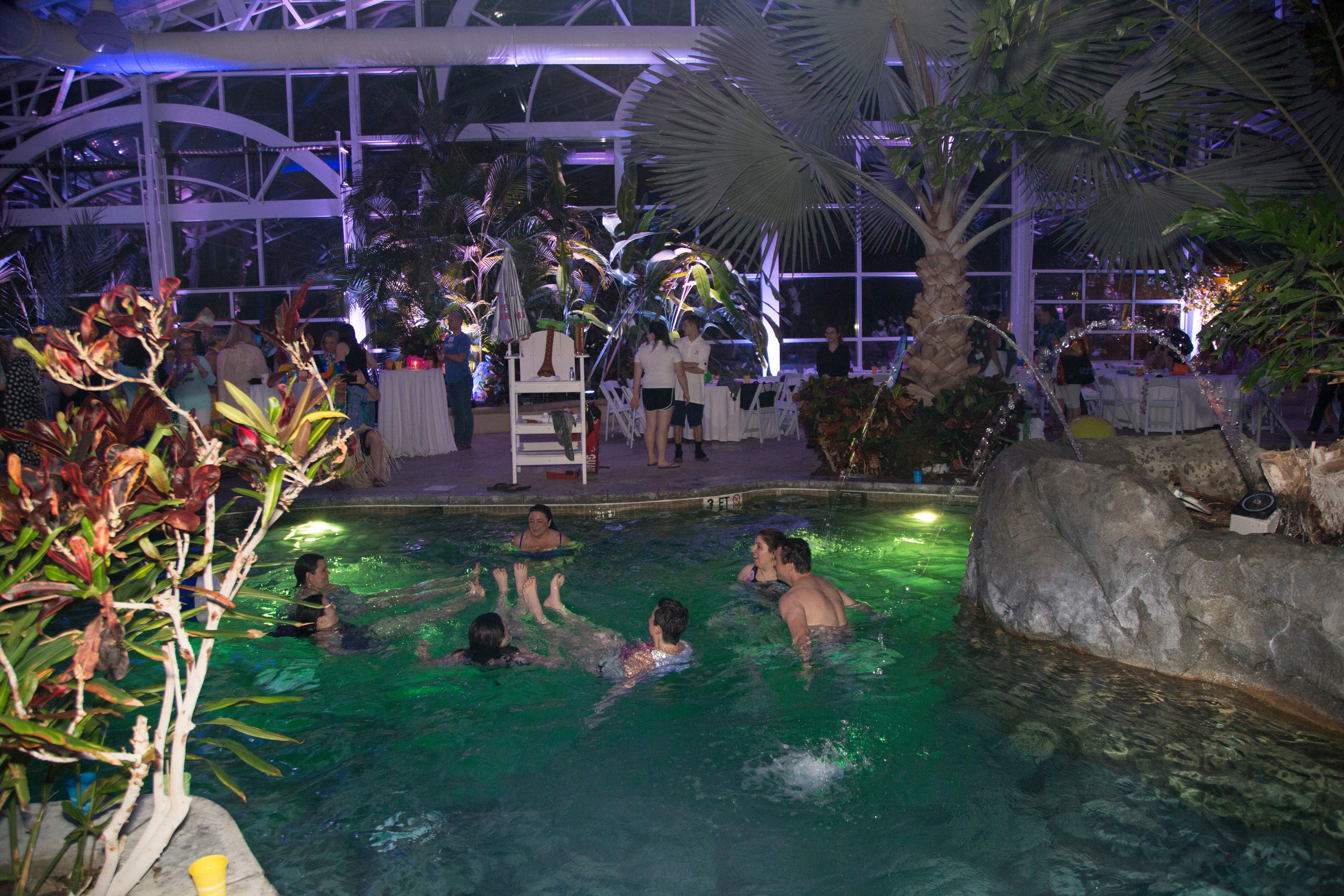 Group of adults swimming in Biosphere pool complex. 