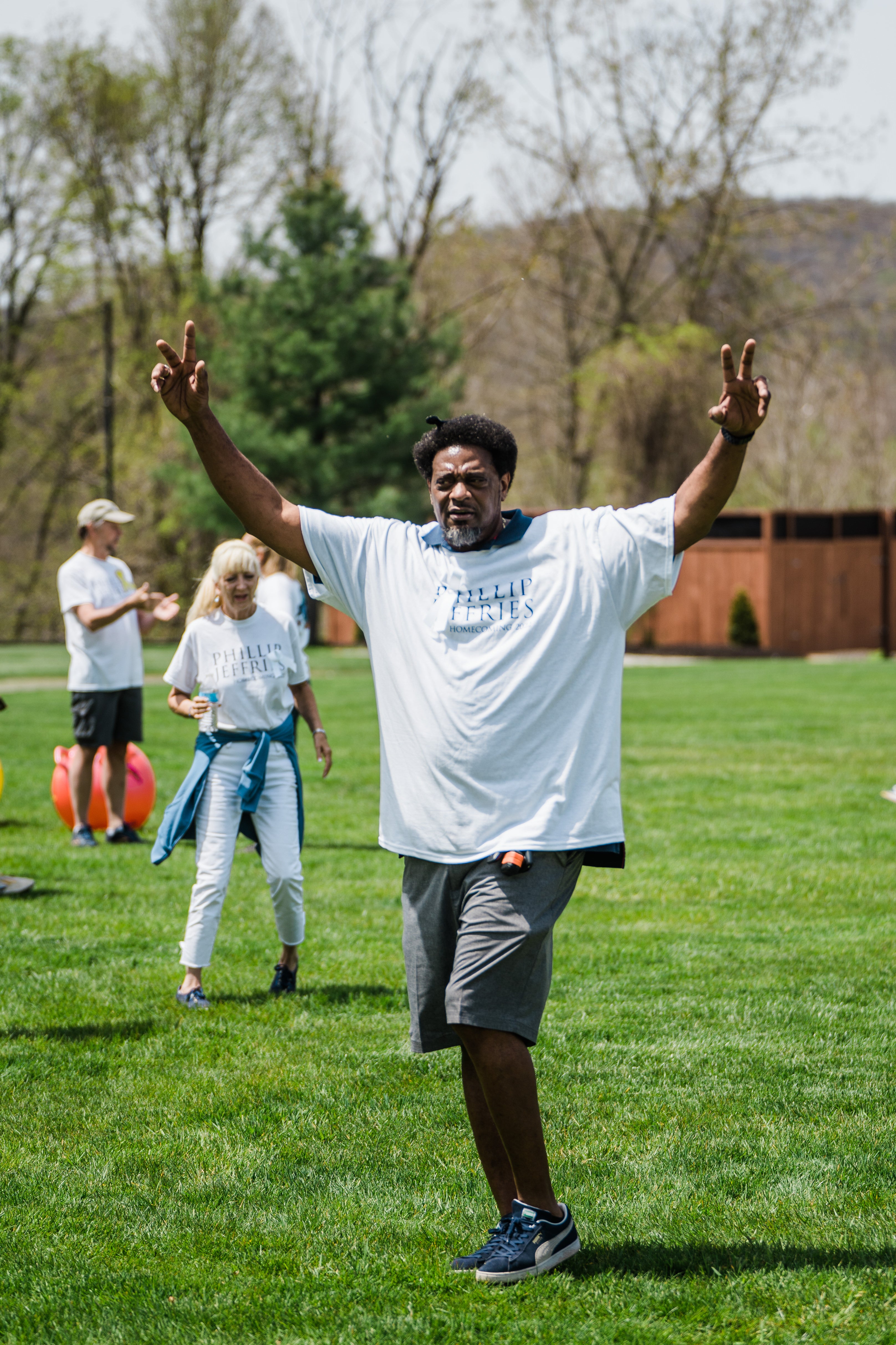 Man raises arms in the air.