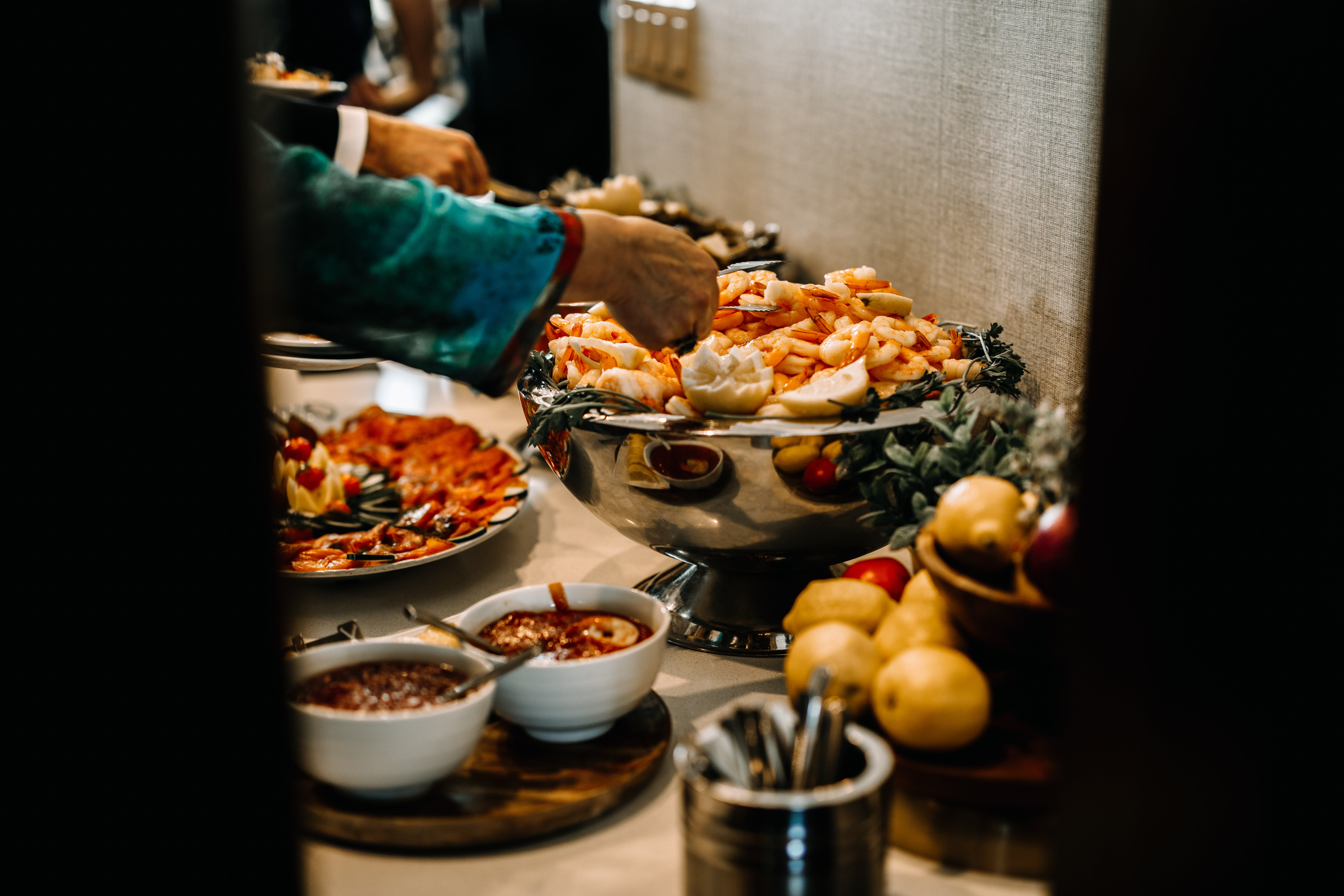 Man serving himself shrimp. 