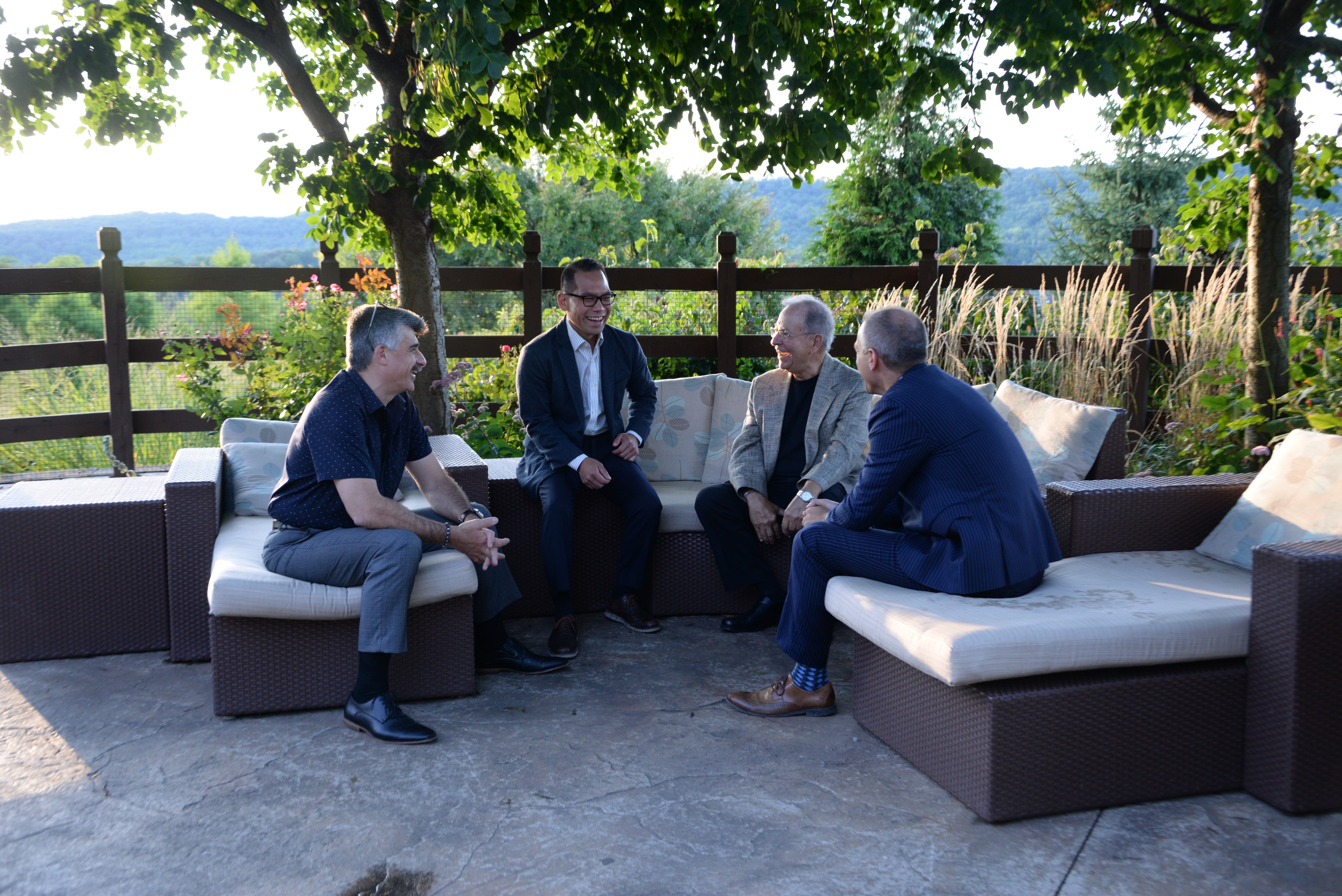 Group of men chatting in the Che'f Garden