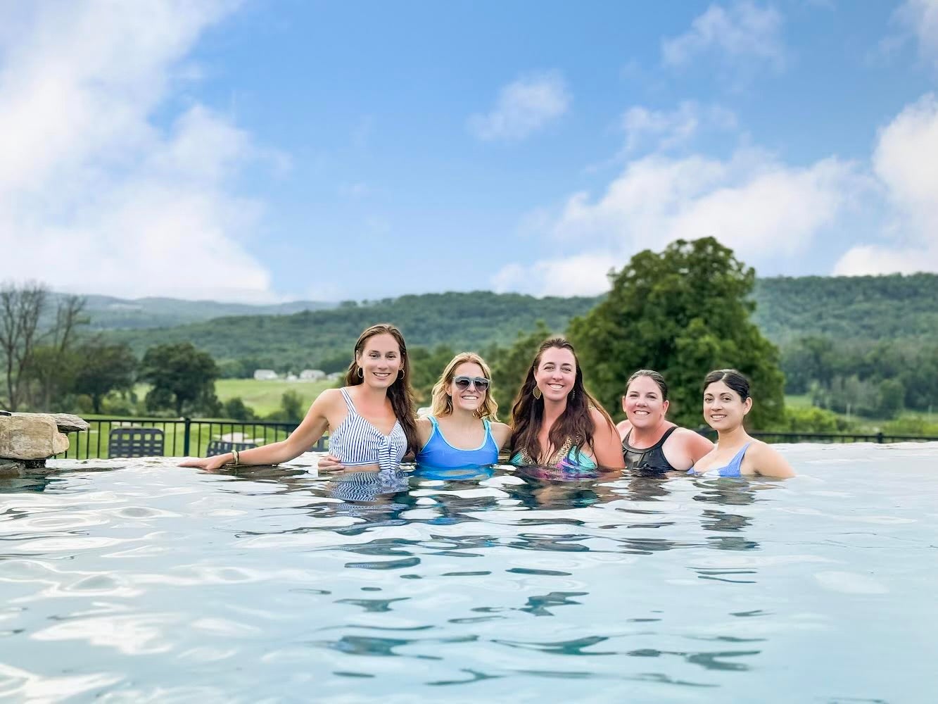 Four ladies in pool together. 