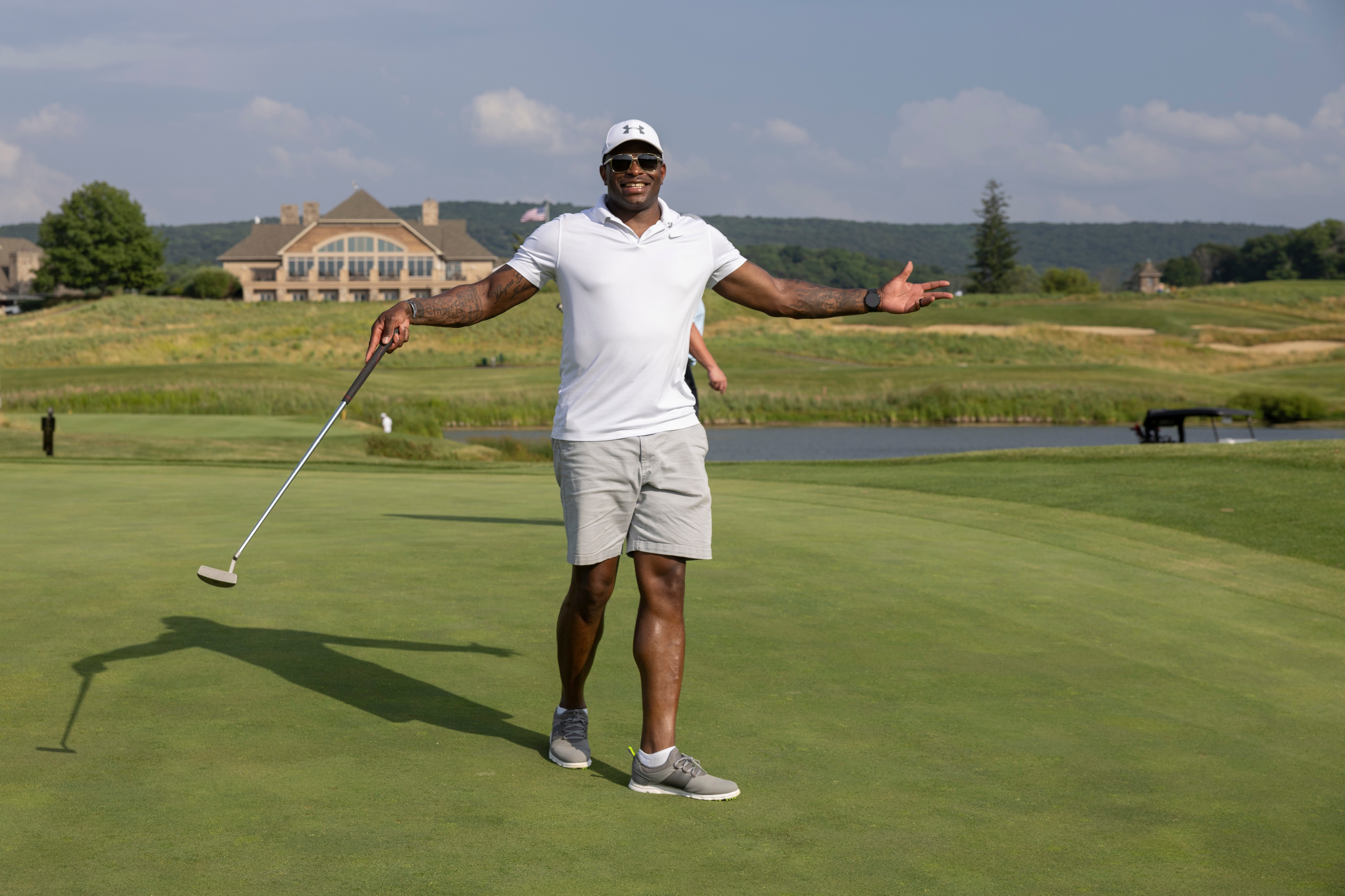 Golfer with arms raised out wide. 