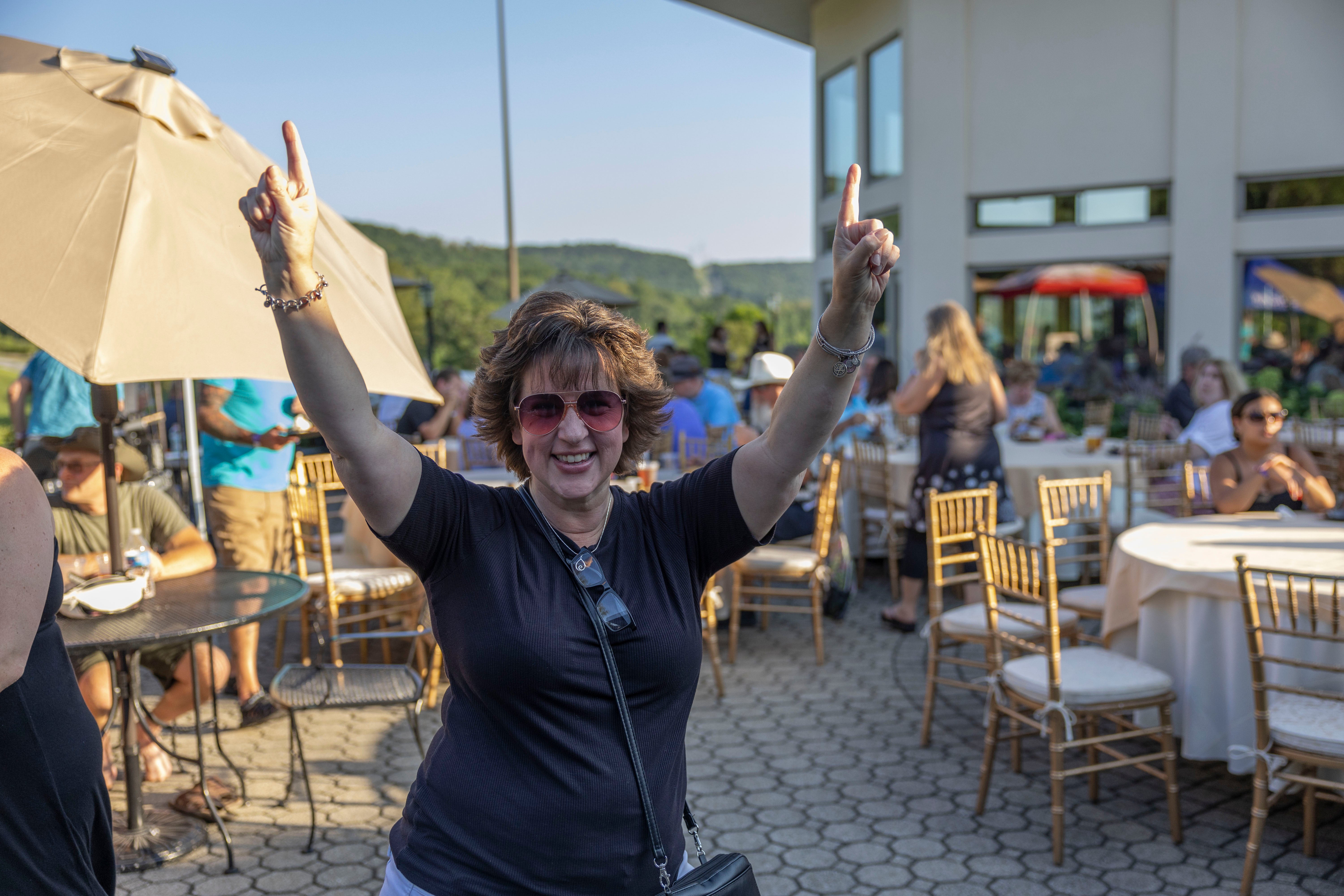 Woman throws her hands in the air.