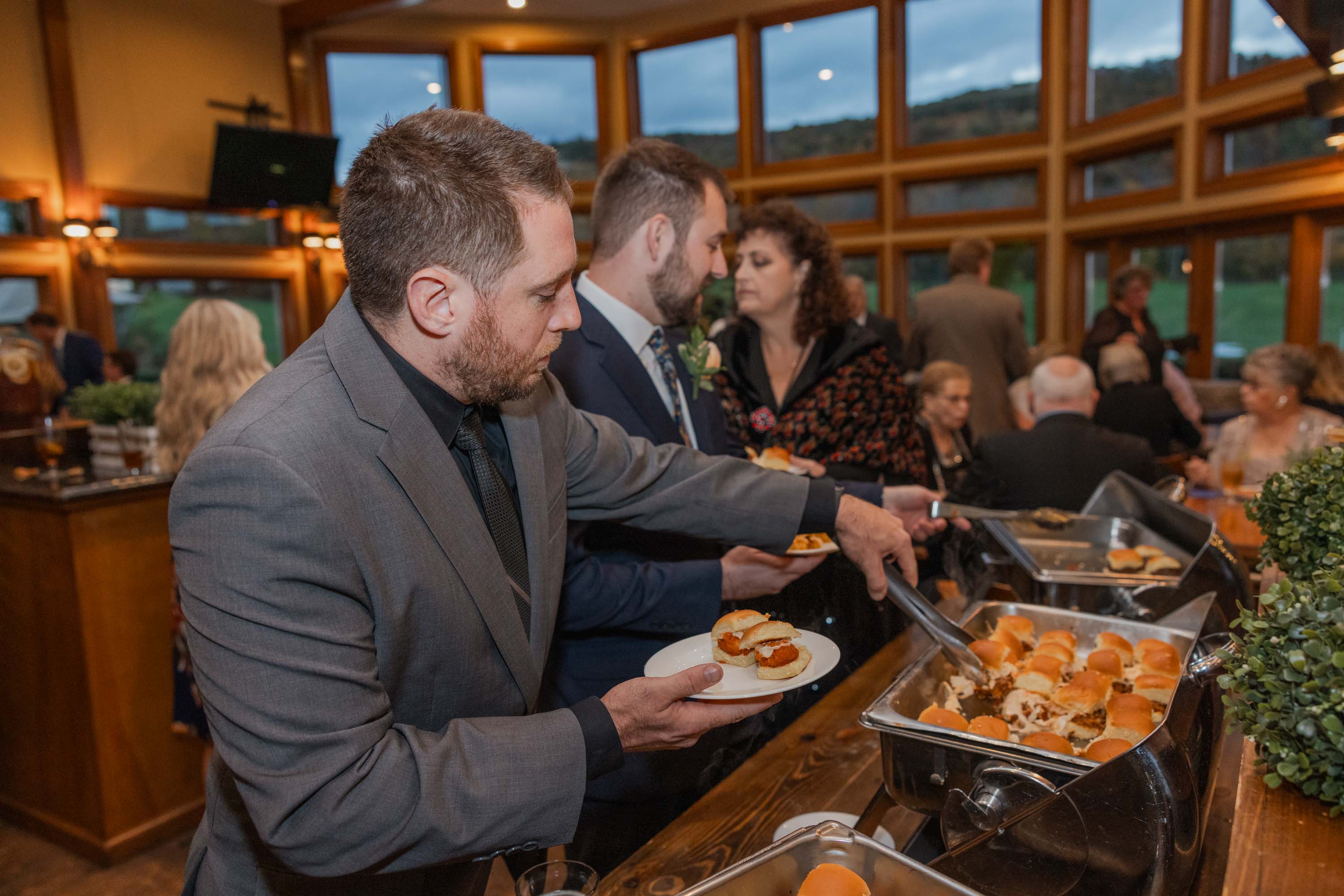 Man choosing food from buffet at Black Bear Bear Den Grille.