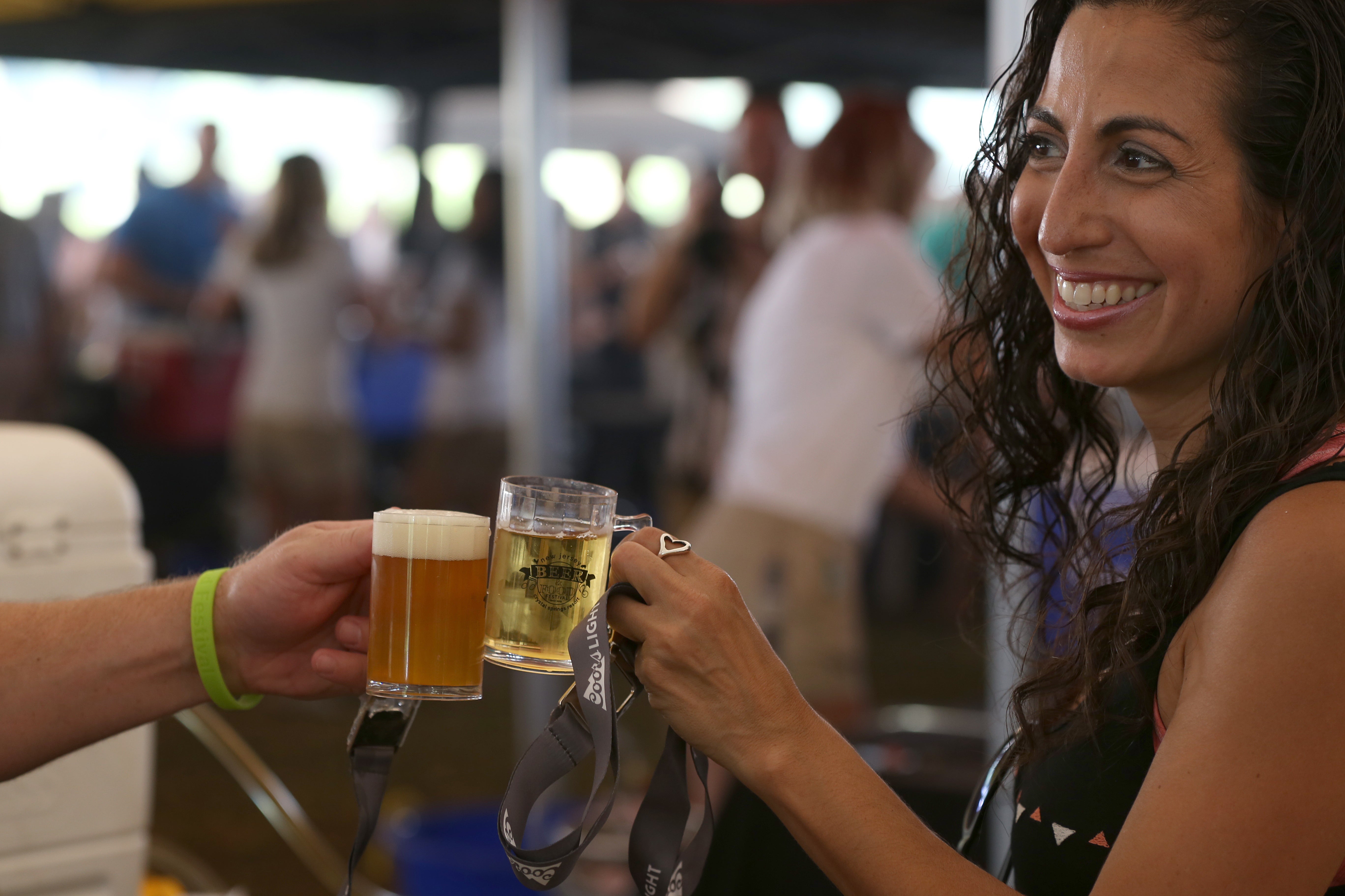 Woman holding beer sample.