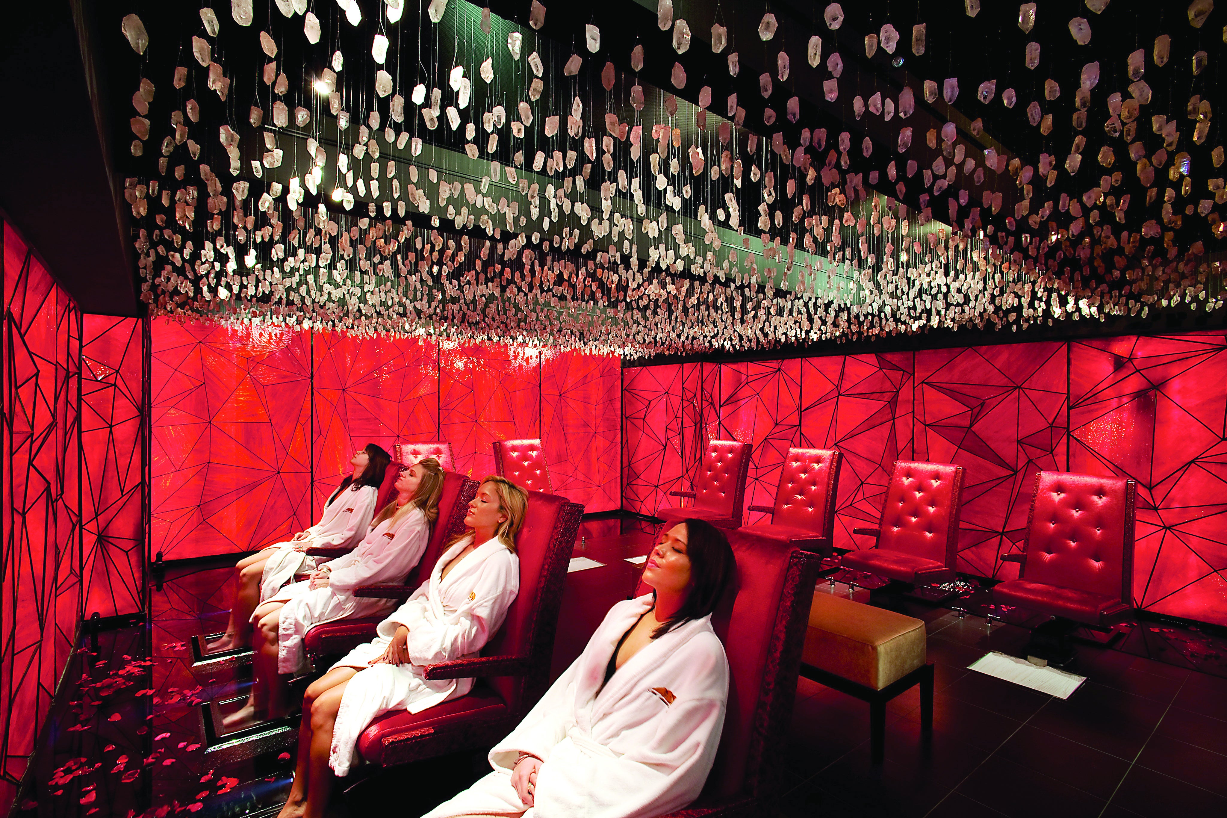 Three woman sit relaxed in chairs in Reflections Spa crystal room.
