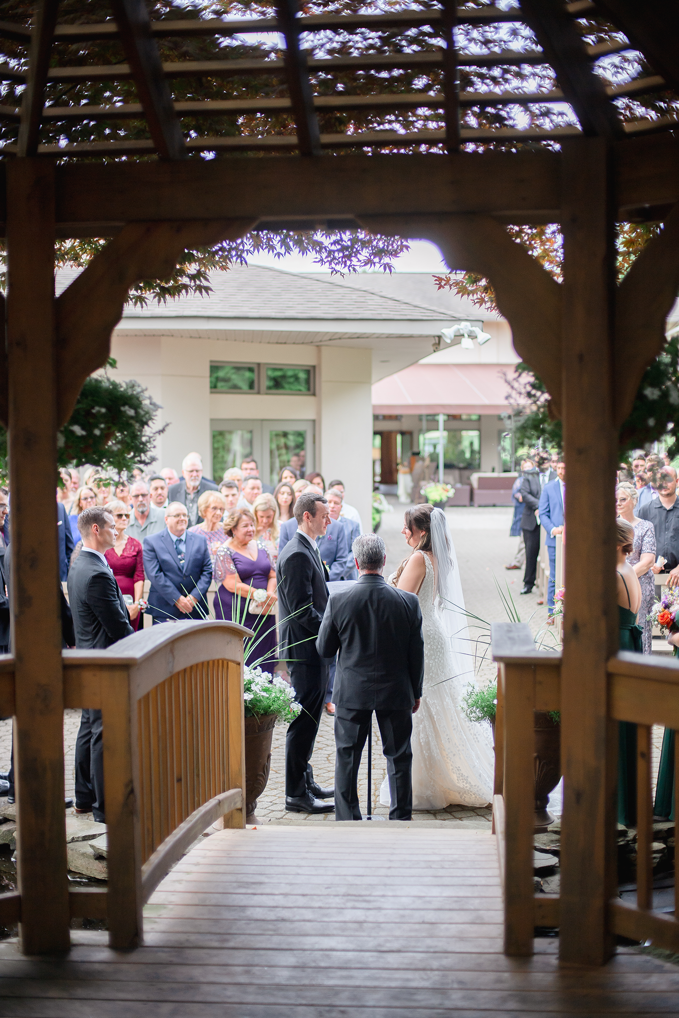 Bride and groom holding hands during ceremony at Black Bear wedding.