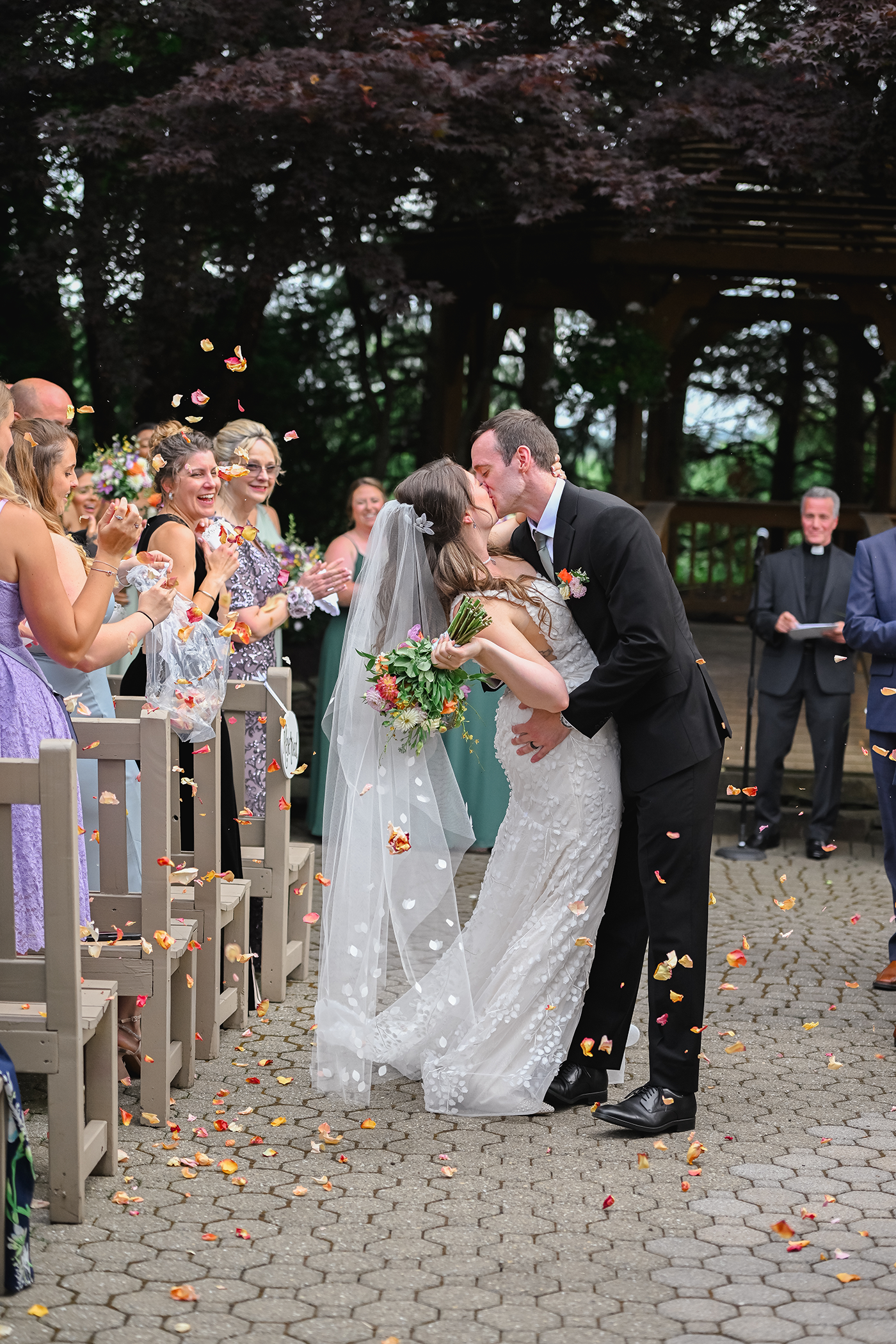 Groom dips bride and gives her a kiss as they walk back down the aisle at Black Bear wedding ceremony. 