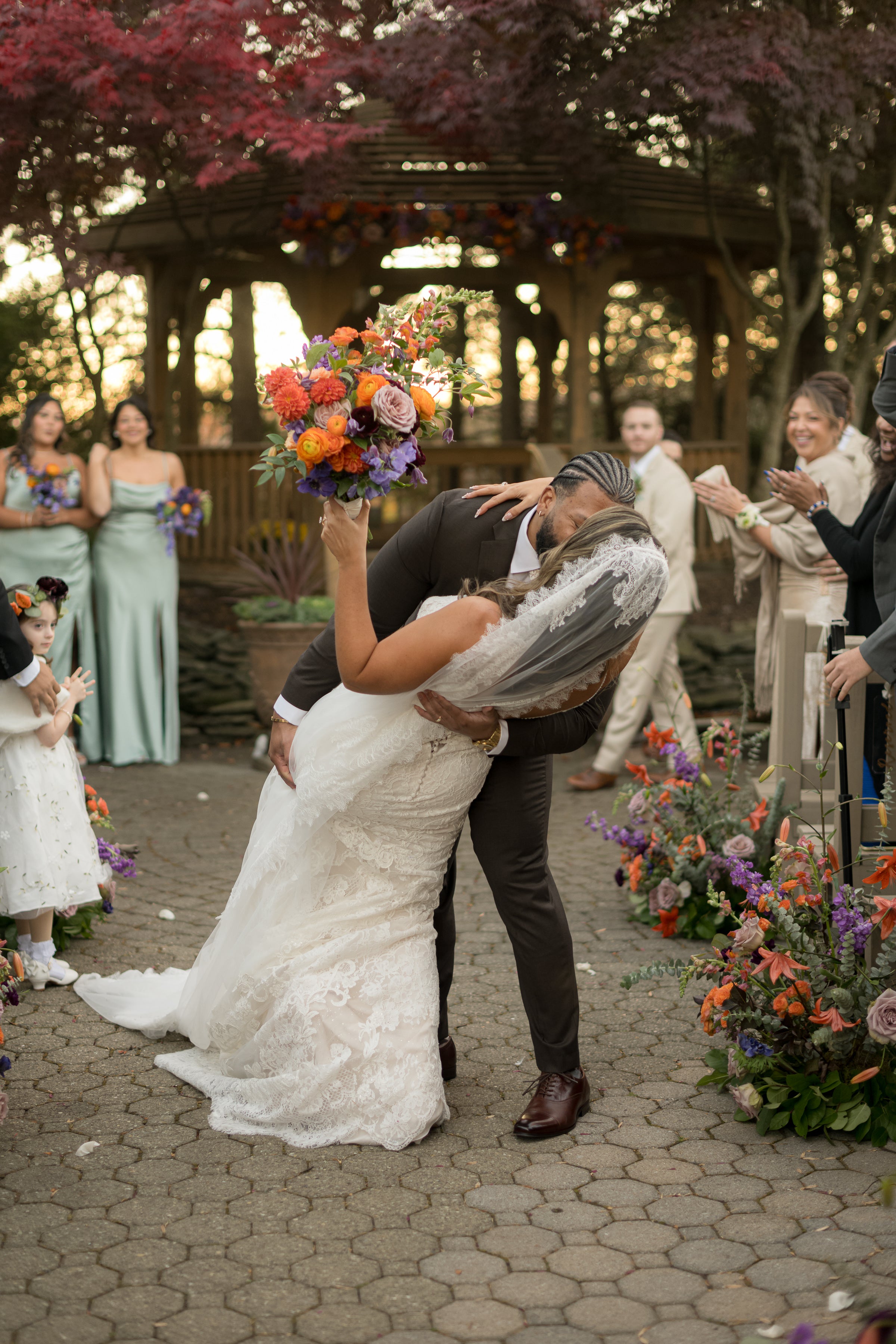 Groom dips bride and gives her a kiss as they walk back down the aisle at Black Bear wedding ceremony. 