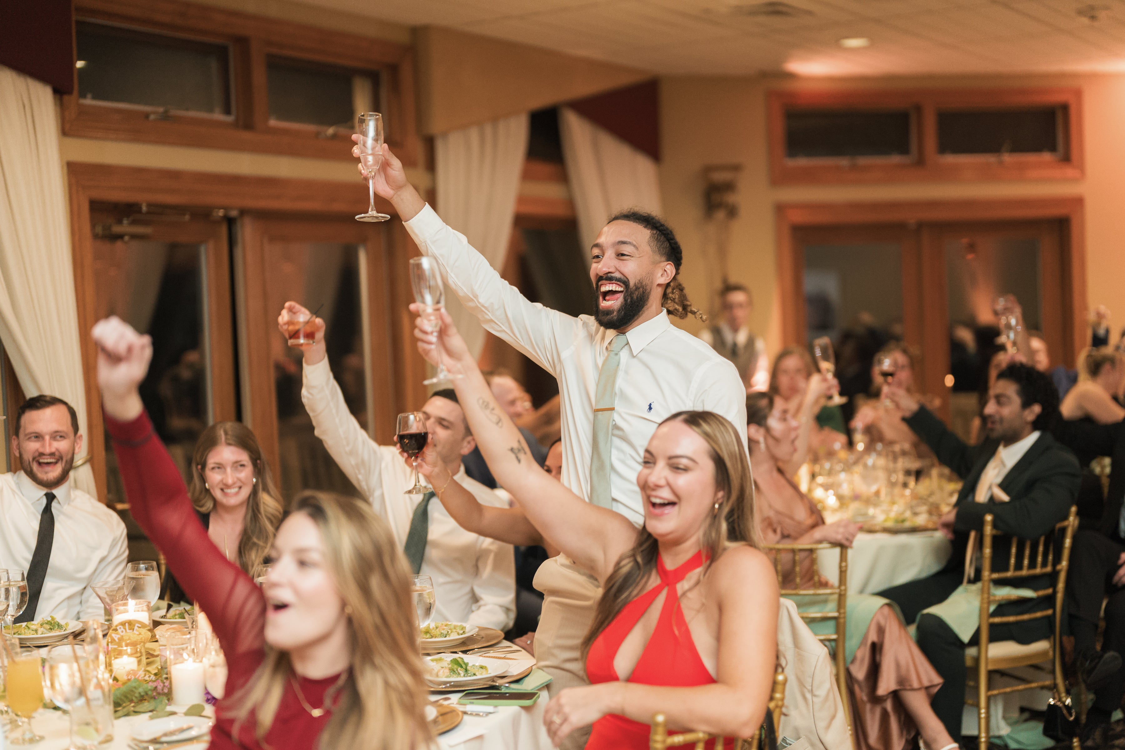 Guests cheerings champagne at Black Bear wedding reception.