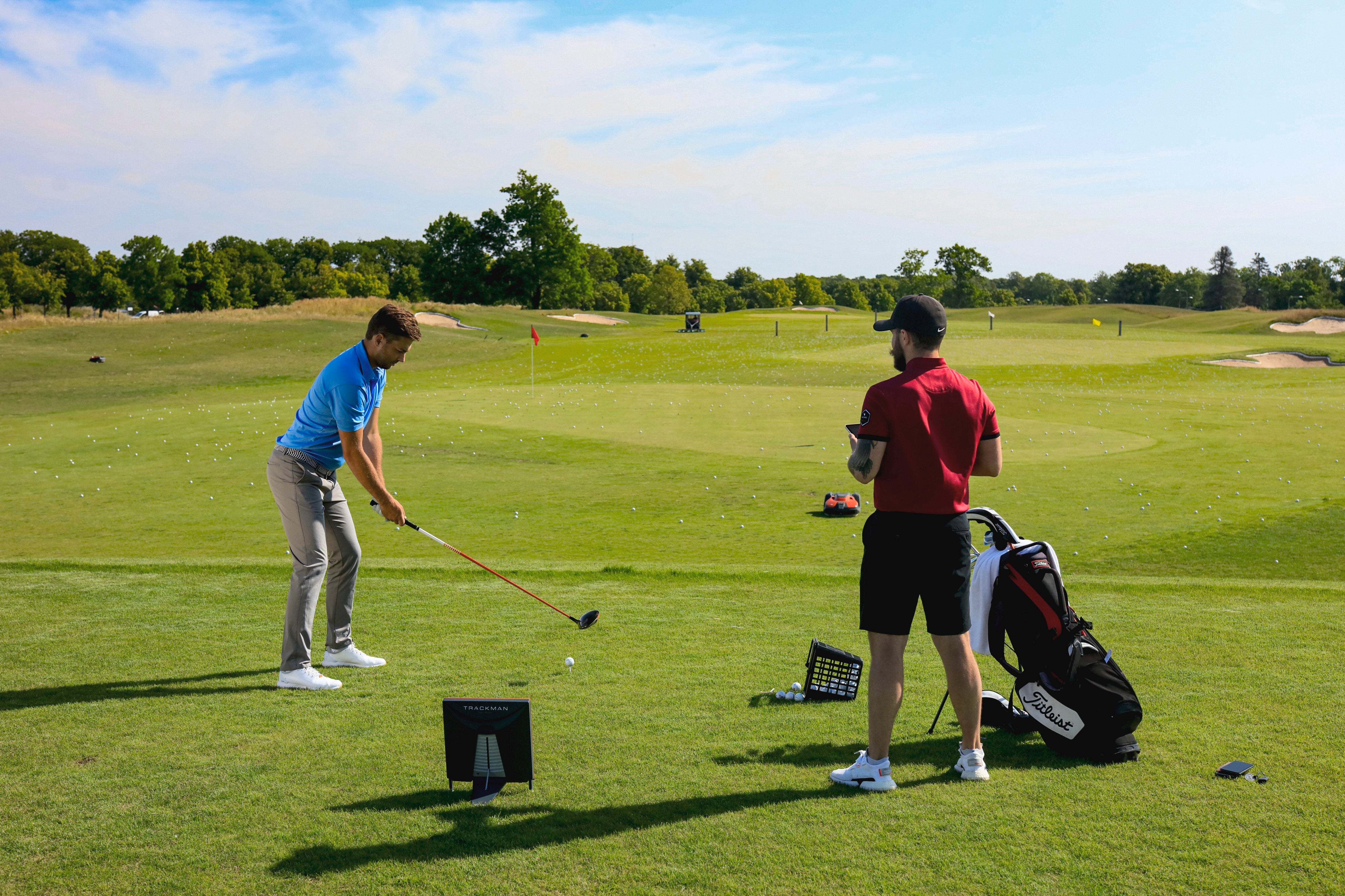 Player and coach on trackman range.