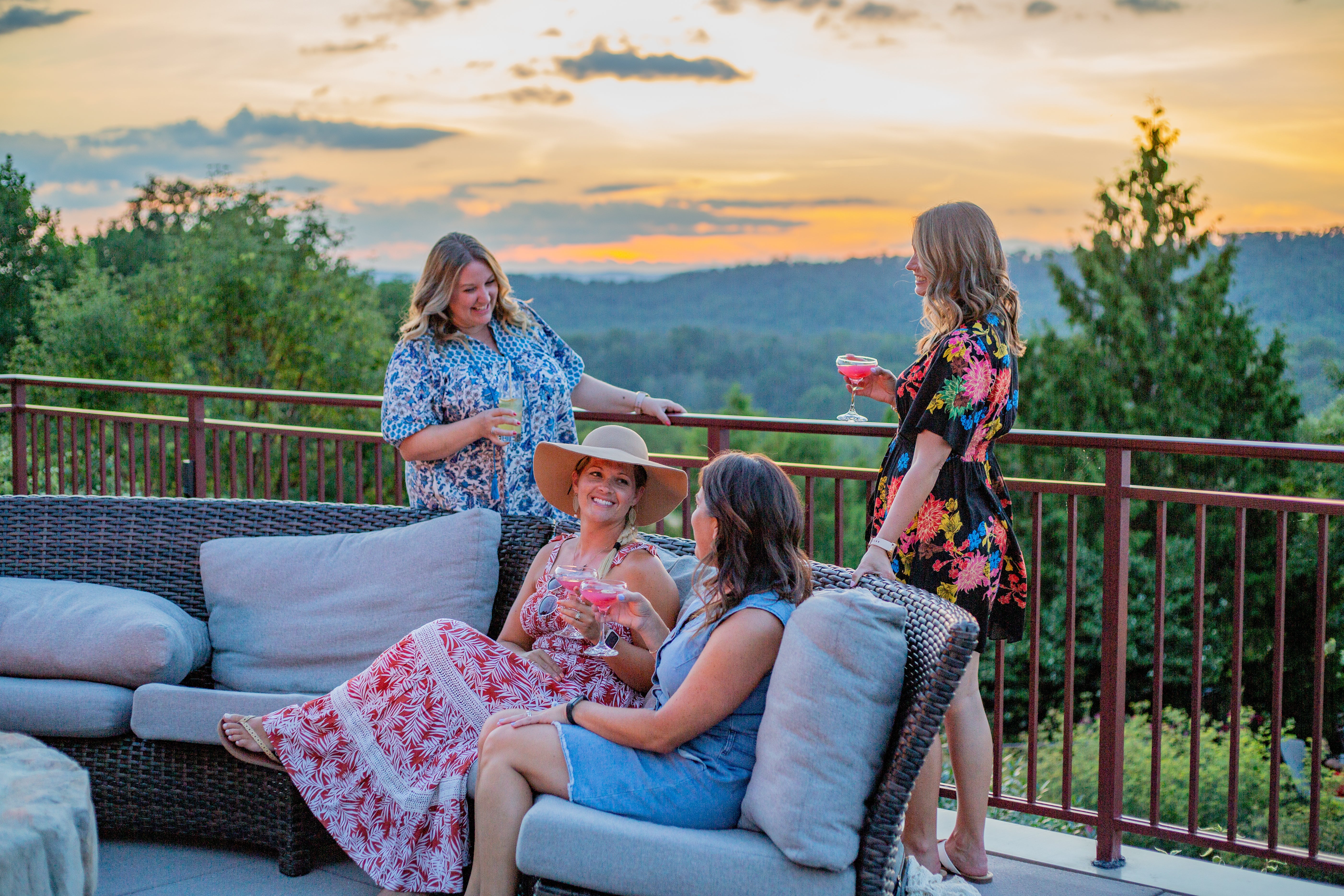 Four girlfriends have drinks on Fire & Water Terrace. 