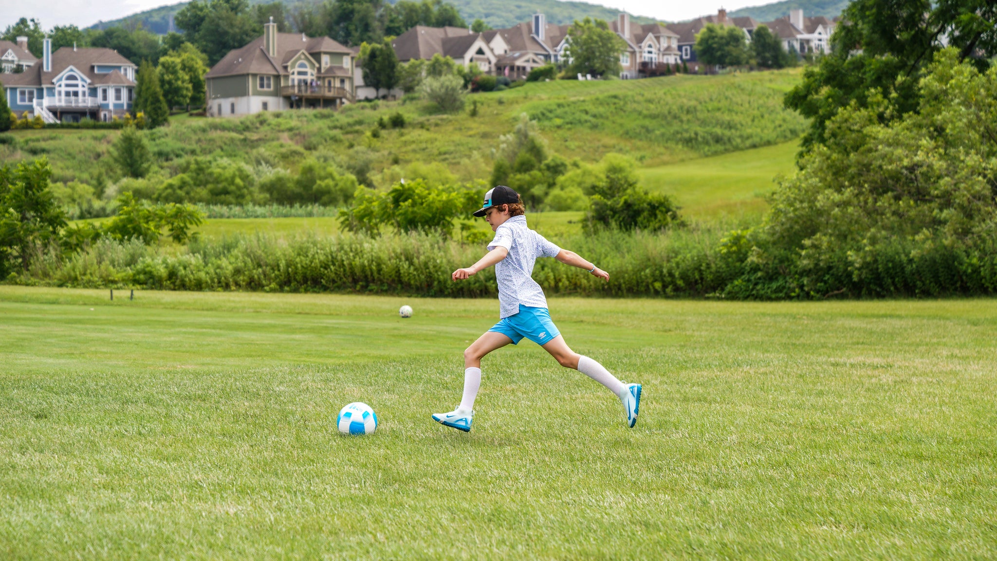 Boy kicking soccer ball