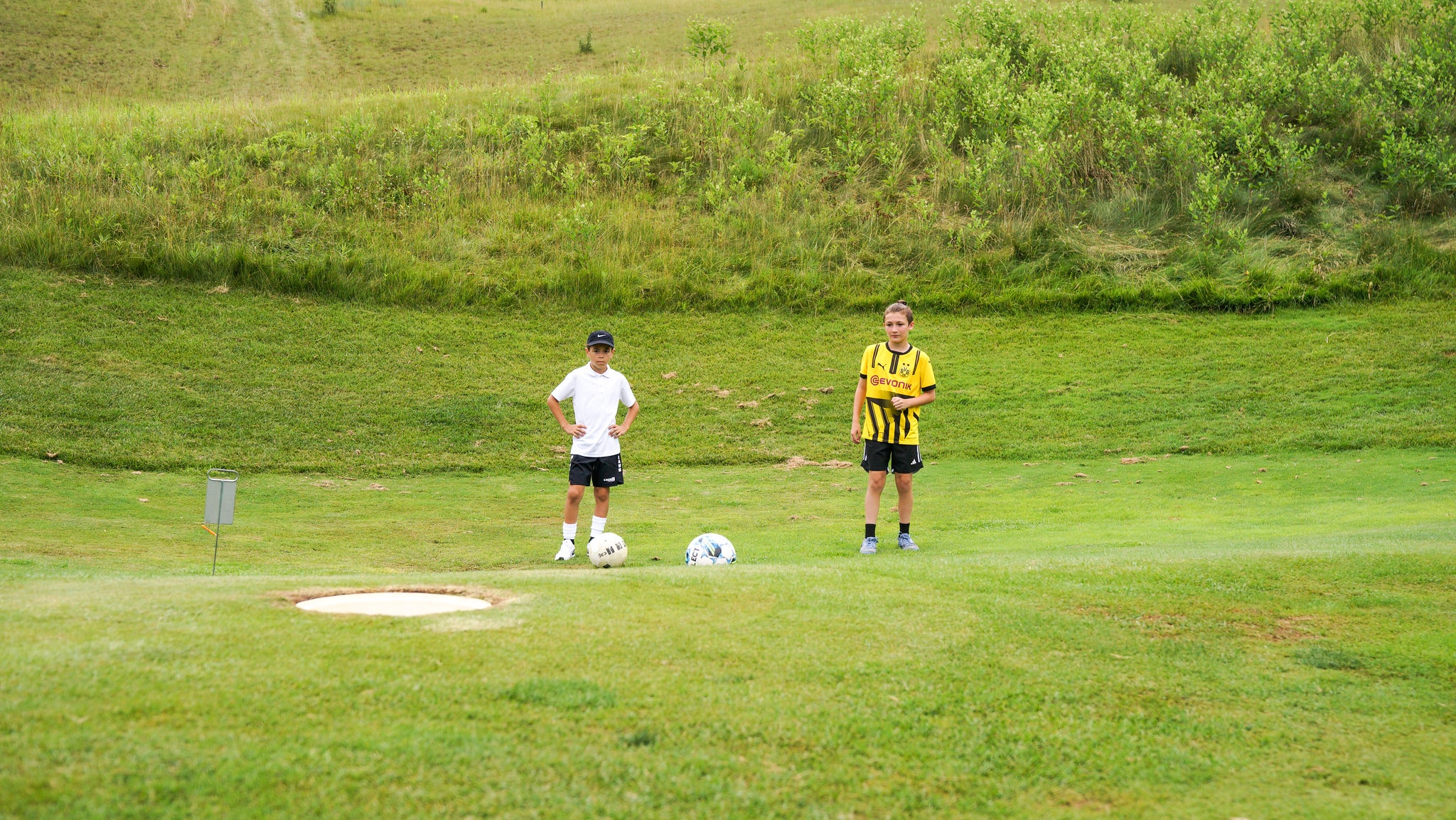 Boys standing by FootGolf goal.