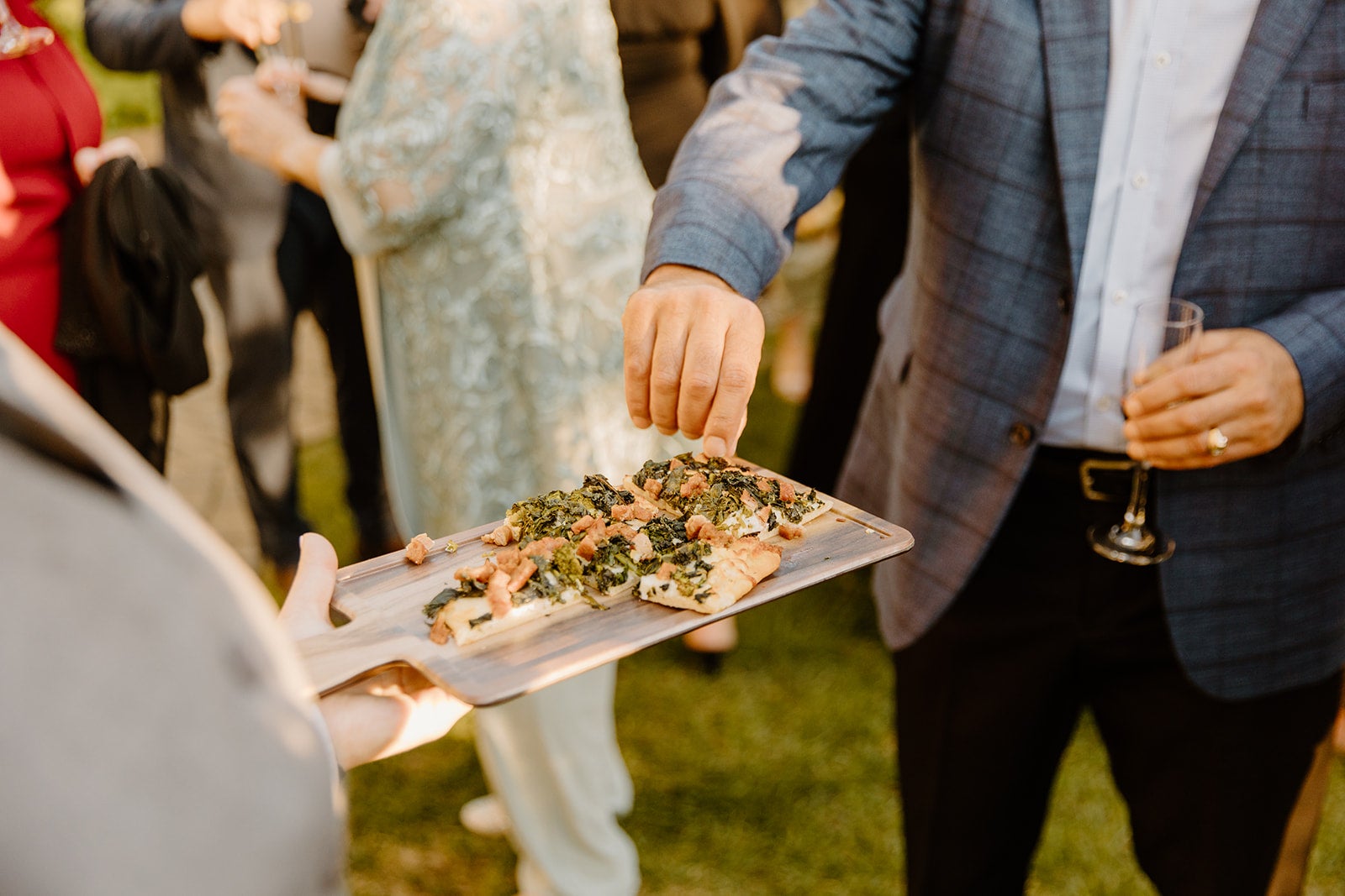 Man reaching for piece of flatbread at Minerals Cocktail Hour. 