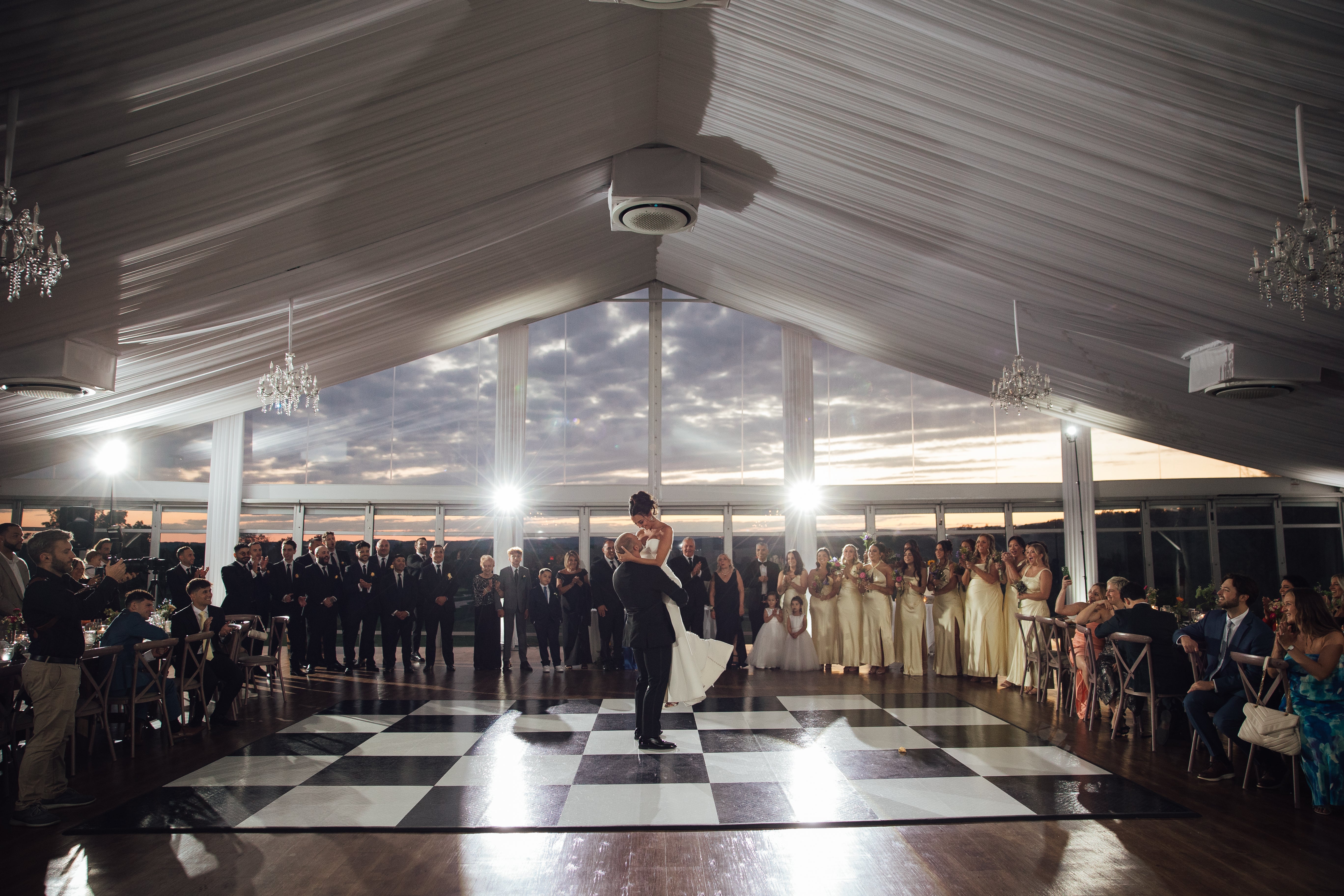 Groom picks up bride during dance at their Big Sky Pavillion wedding.