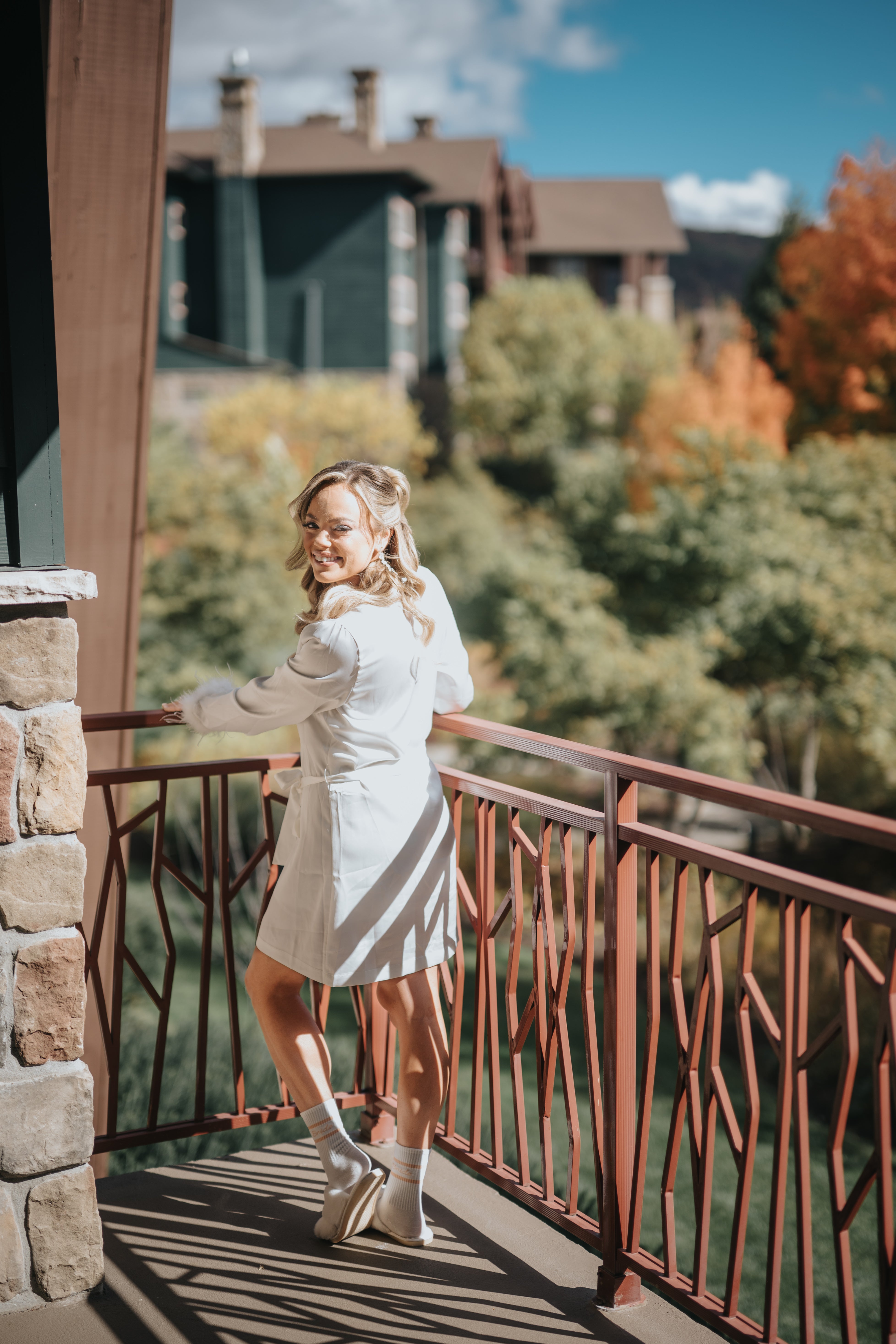 Bride standing on balcony at Grand Cascades Lodge