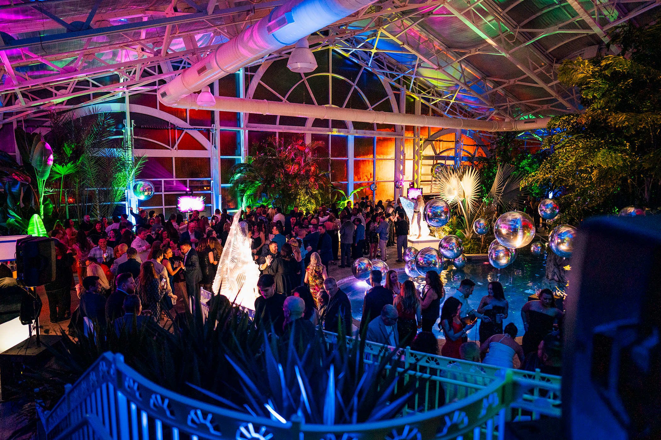 Guests gather for a lively indoor celebration with colorful lighting and festive decorations at Crystal Springs Resort.