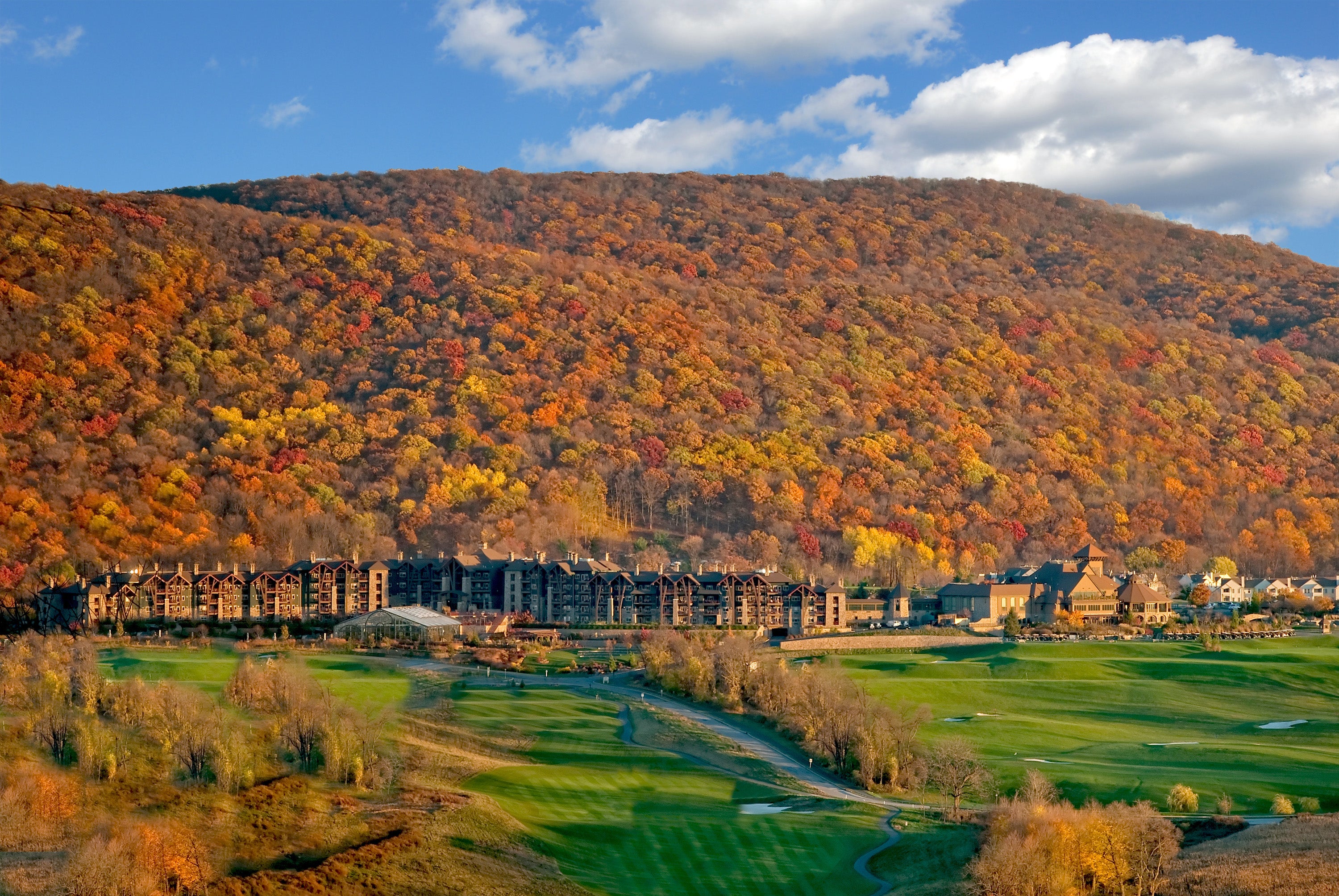 View of fall mountains behind Grand Cascades Lodge at Crystal Springs Resort in NJ