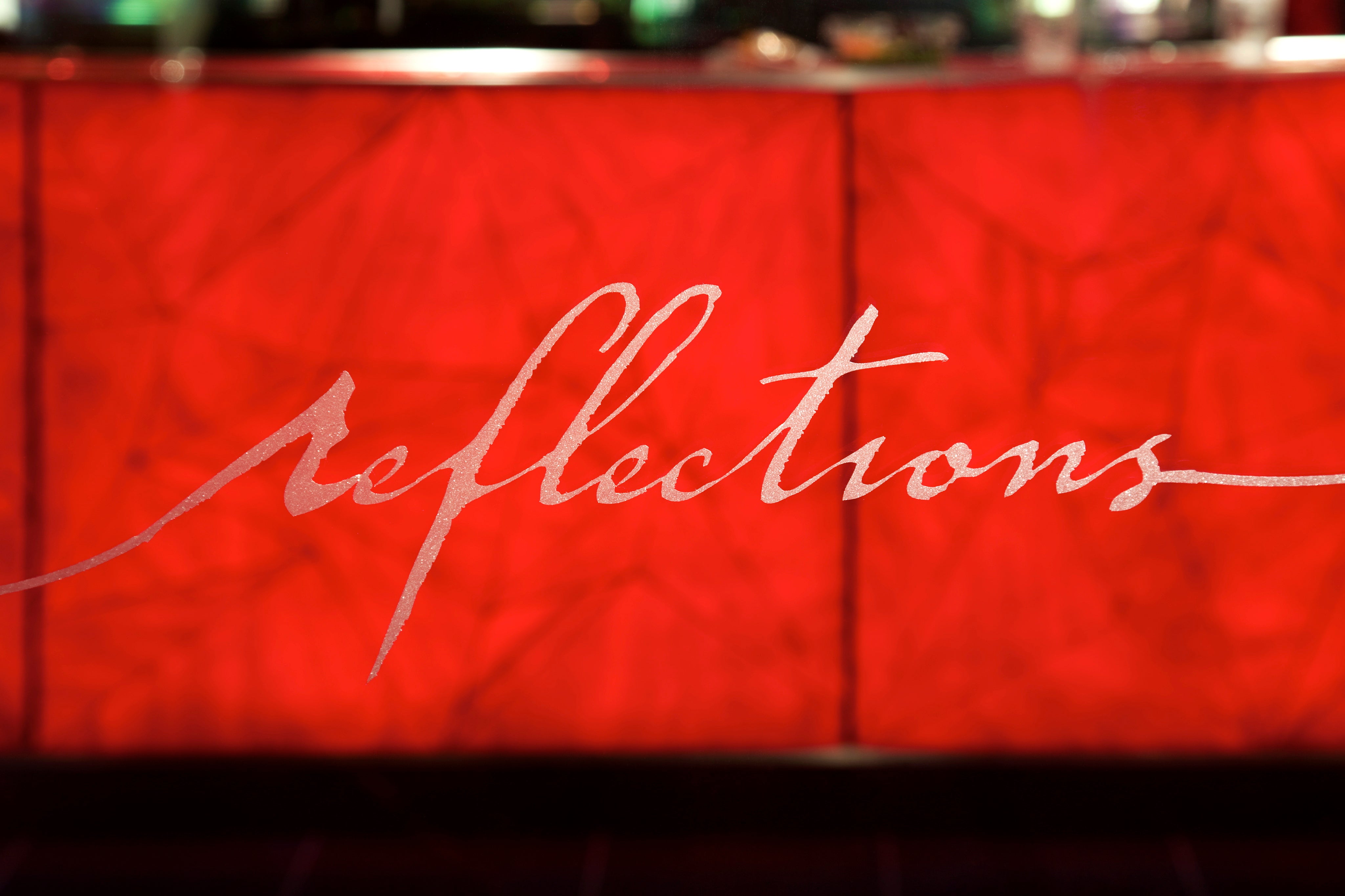 Reflections logo on glass door entrance.