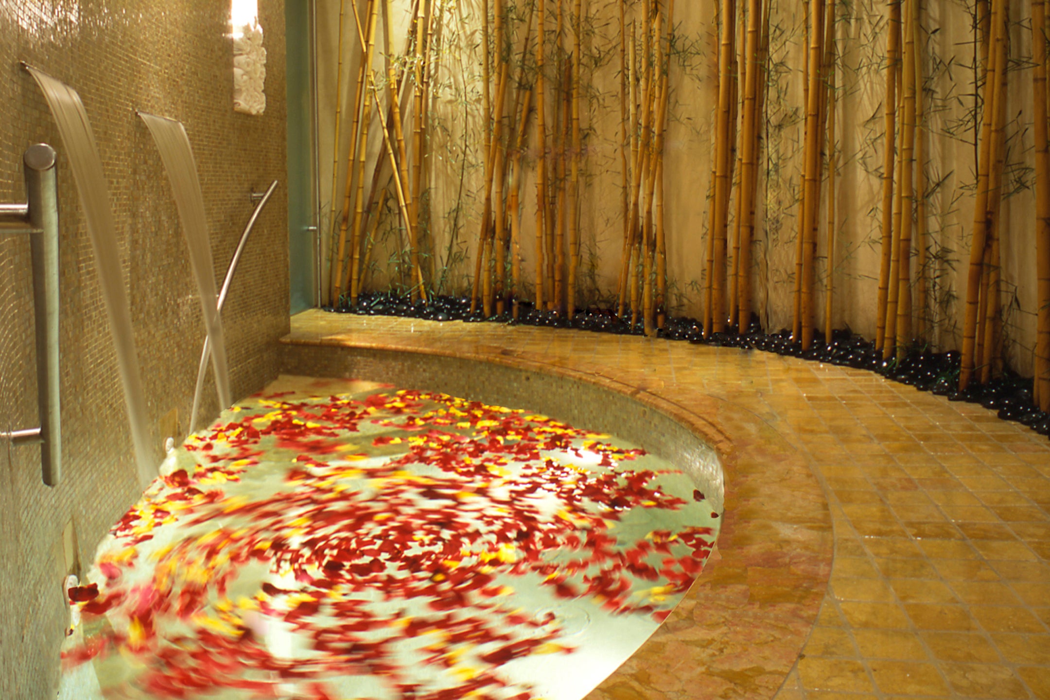 Hot tub at Elements Spa filled with flower petals.