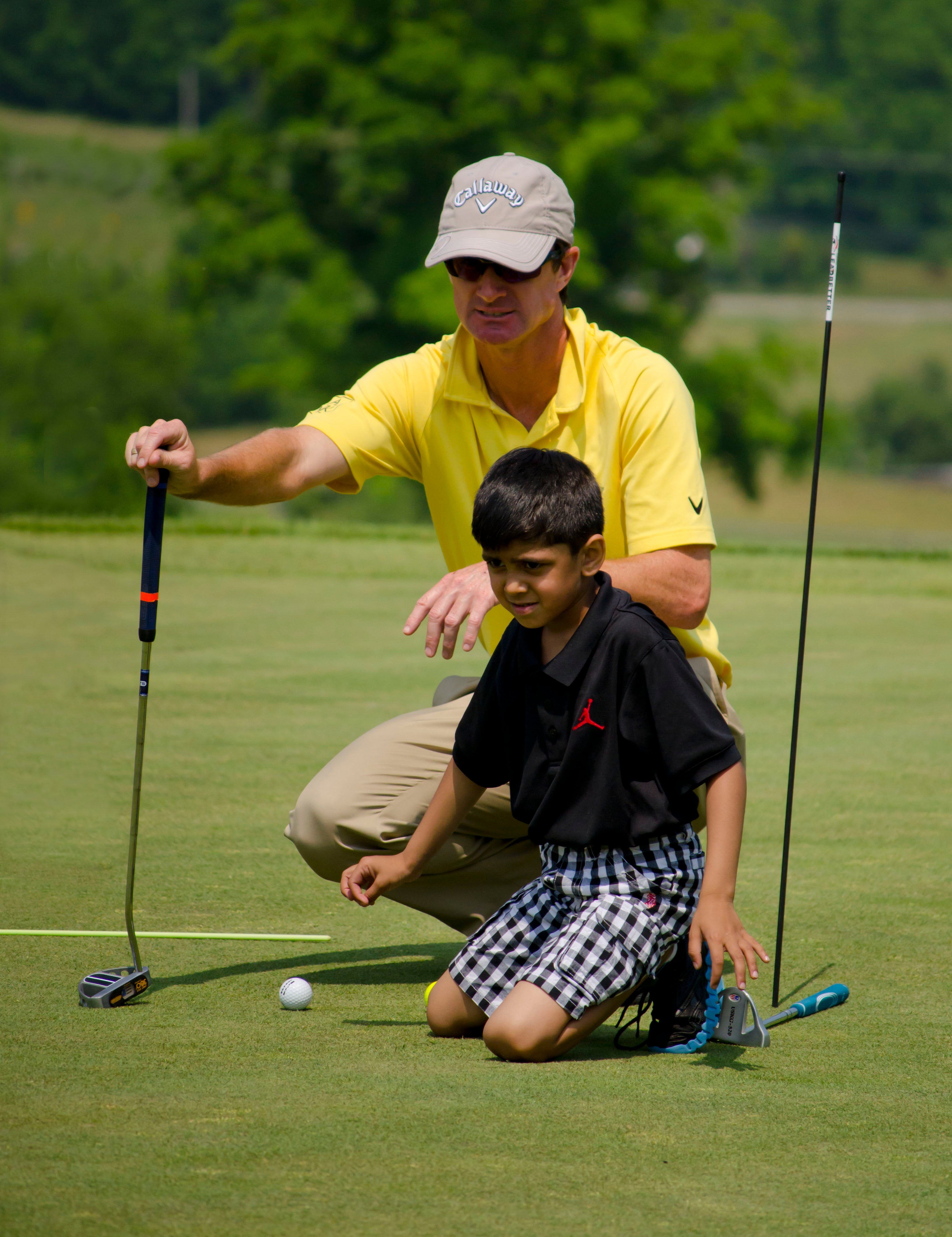 LeadBetter Golf Academy instructor teaching young boy to golf