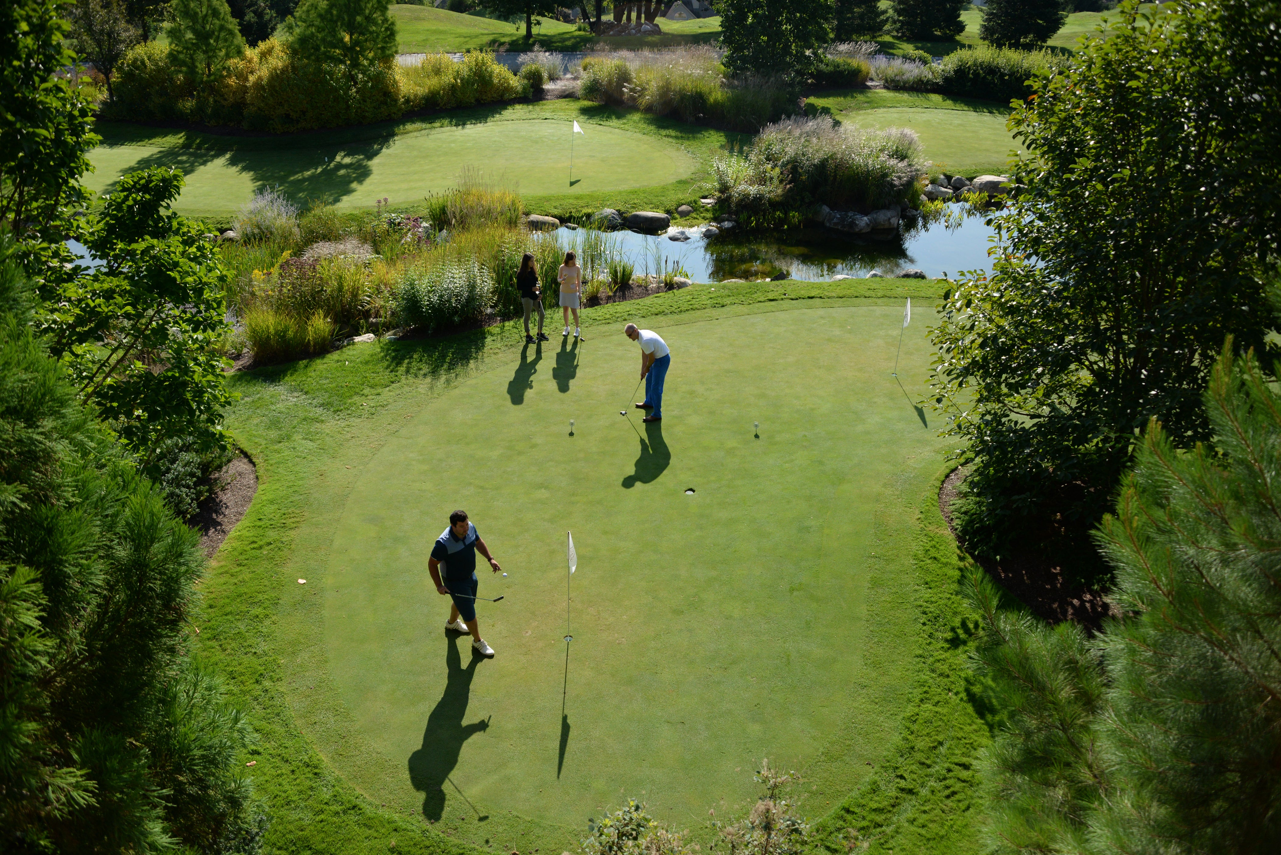 Friends playing on the putting course at Grand Cascades Lodge