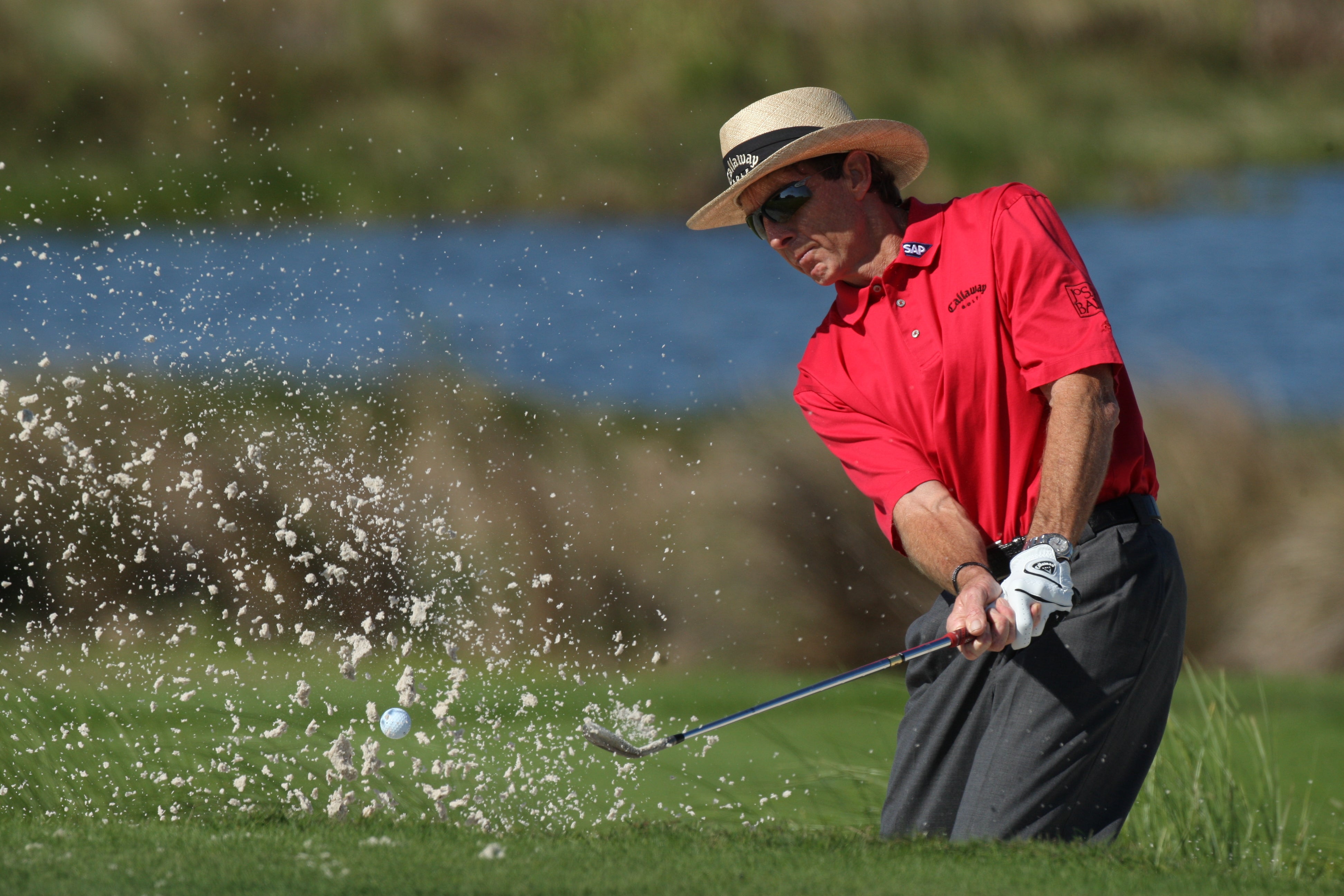 Man in red shirt golfing at Crystal Springs Resort
