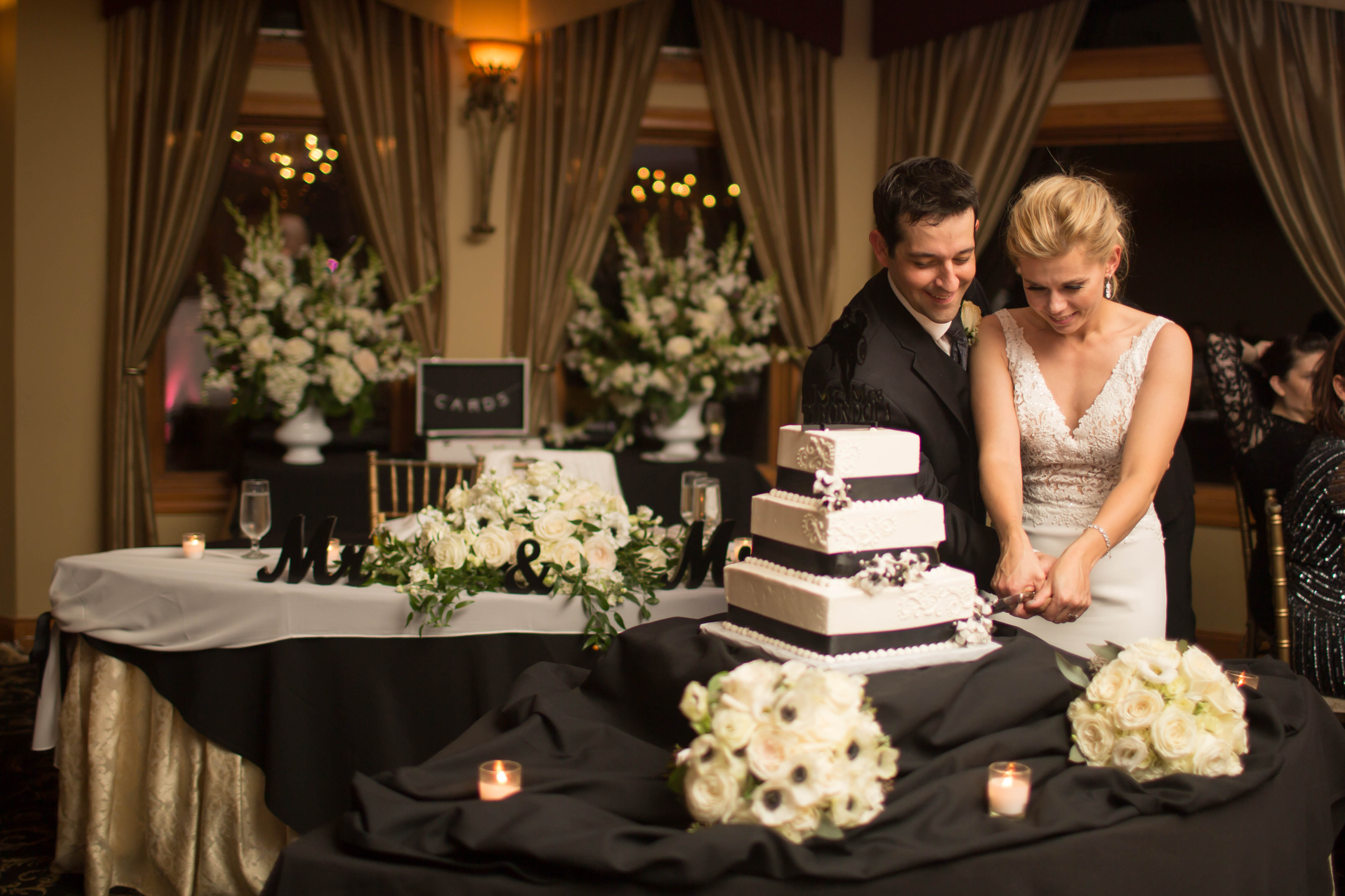 Bride and groom cutting wedding cake at Black Bear wedding reception