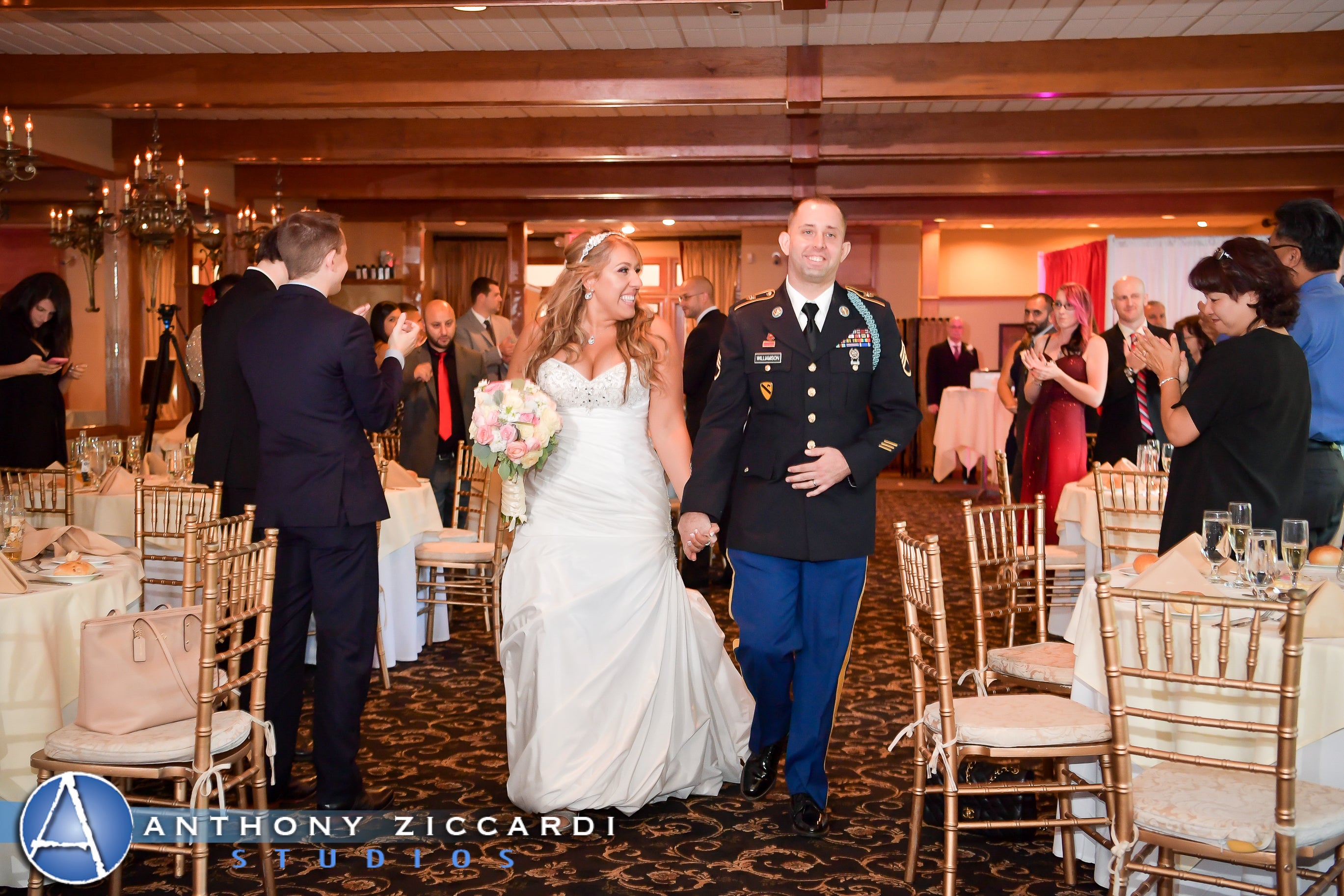 Military wedding couple holding hands walking into wedding reception