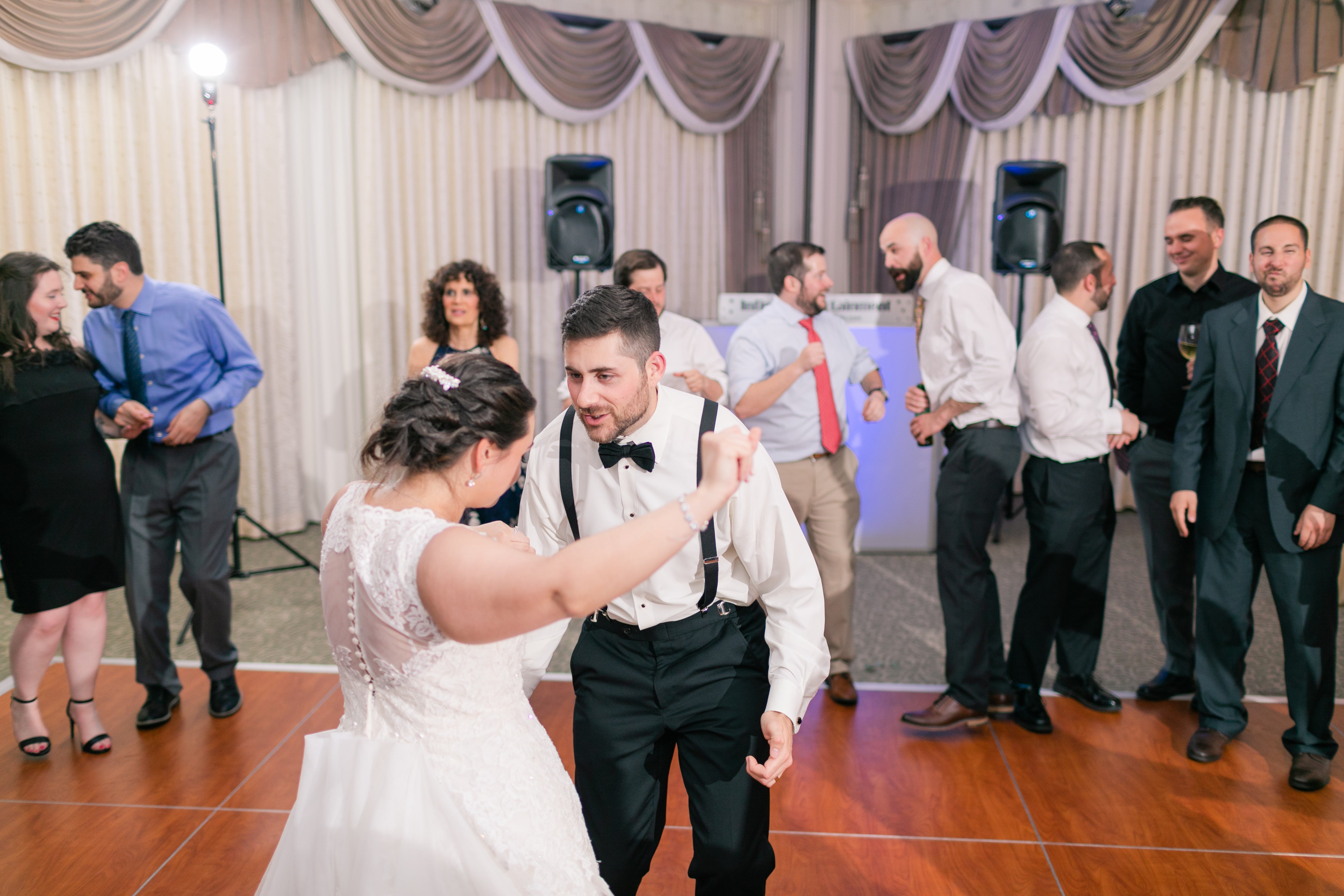 Bride and groom dancing with wedding guests